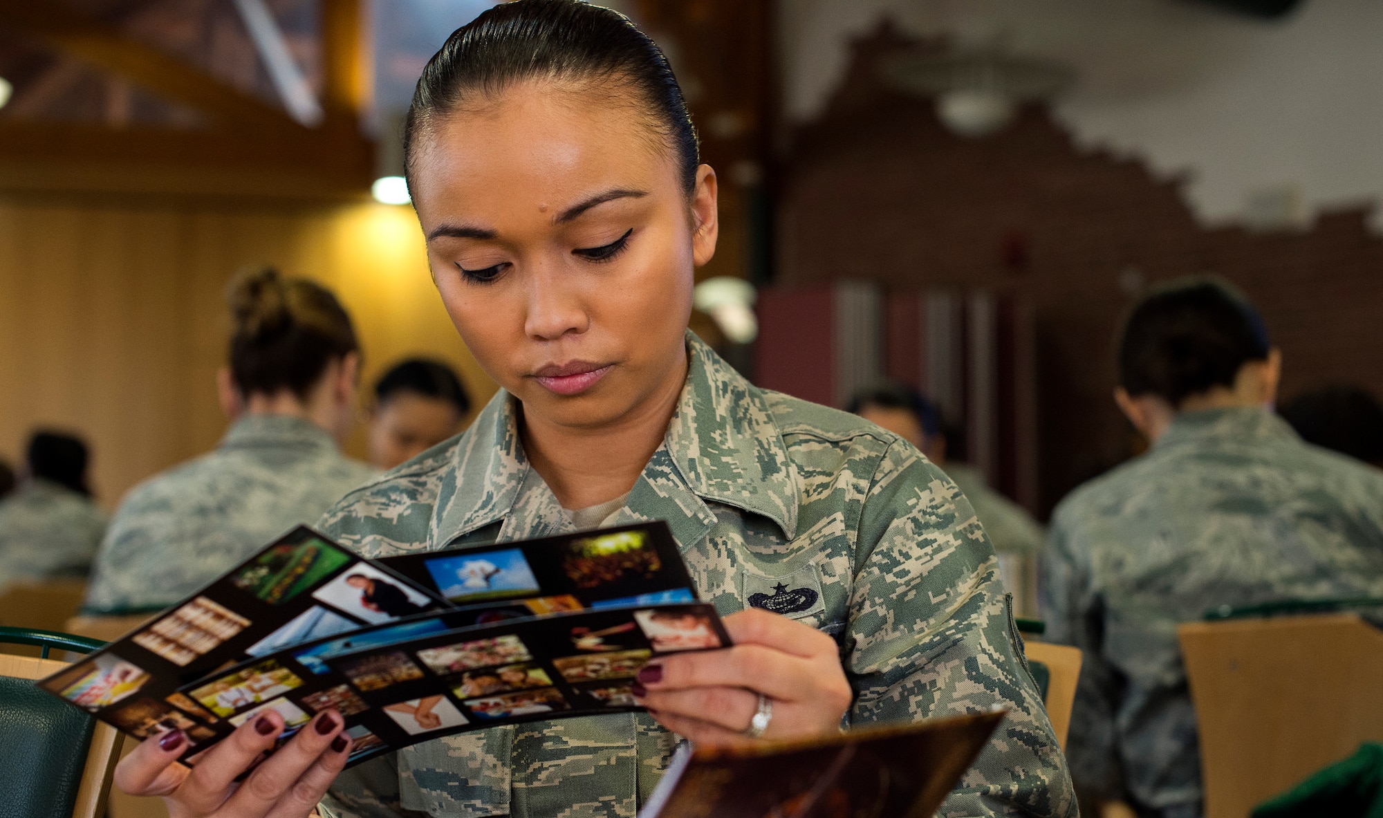 Staff Sgt. Kathleen Mustafa, 86th Aircraft Maintenance Squadron personnel programs NCO in charge, reads through cards to help determine her personality during a seminar hosted by the ‘Lets Connect’ group at Ramstein Air Base, Germany, March 10, 2015. The forum was designed to confront issues unique to women balancing a military career and a personal life at home. Attendees had the opportunity to hear from women in leadership roles throughout the Kaiserslautern Military Community and ask them questions. They also took part in an exercise to better understand themselves and others around them, which in turn can foster leaders who can recognize the talents and potential of their followers. (U.S. Air Force photo/Senior Airman Damon Kasberg)