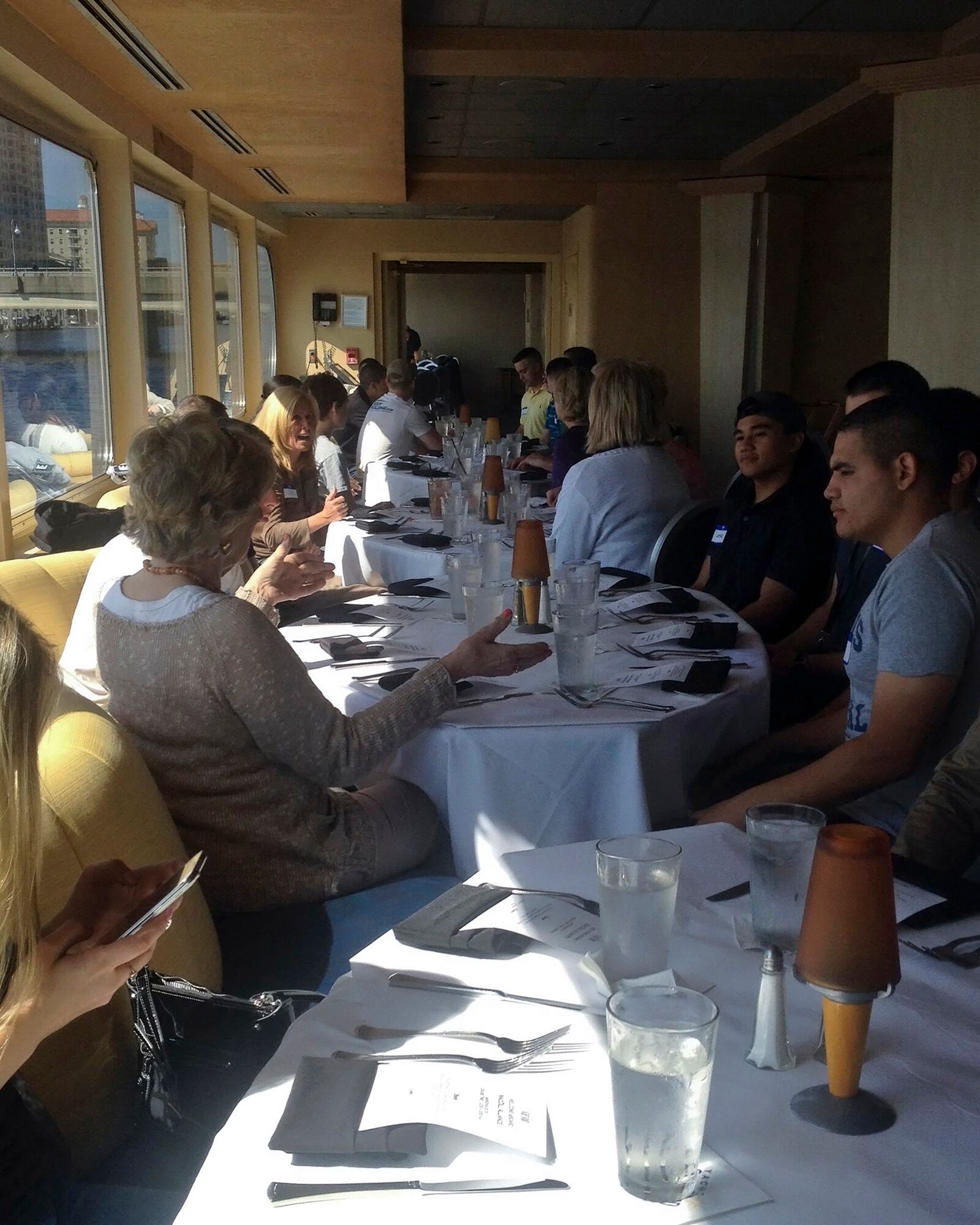 Service members assigned to MacDill Air Force Base, Fla., attend the 5th Annual Enlisted Meet & Greet Reception event in Tampa, Fla., March 8, 2015. The two-hour cruise was designed to introduce E-1 through E-5s to local community and business leaders in the Tampa Bay community. (U.S. Air Force photo by Airman 1st Class Danielle Conde/Released)