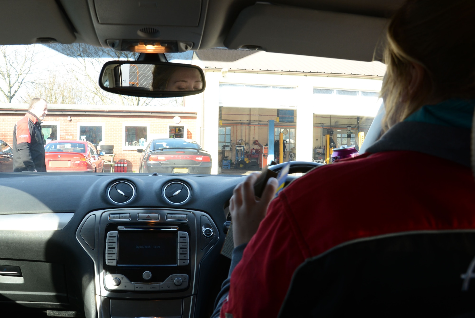 Natasha Johnson, right, 100th Force Support Squadron Auto Hobby Shop receptionist from Steilacoom, Wash., demonstrates how eating a snack means she is unable to keep her eyes on the road so is unable to react when a pedestrian walks in front of the vehicle March 6, 2015, on RAF Mildenhall, England. Driving is something most people do as part of everyday life in order to go about their business. With less than favorable conditions such as weather, wildlife, and winding narrow roads it’s no wonder accidents can happen, however good the driver may be. (U.S. Air Force photo by Gina Randall/Released)