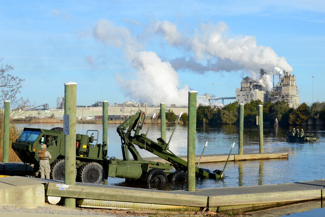 An Army common bridge transporter waits to pull out of the Sampit River after offloading a bridge erection boat as a part of the Vigilant Guard South Carolina exercise at the Carroll Ashmore Campbell Marine Complex in Georgetown, S.C., March 7, 2015.