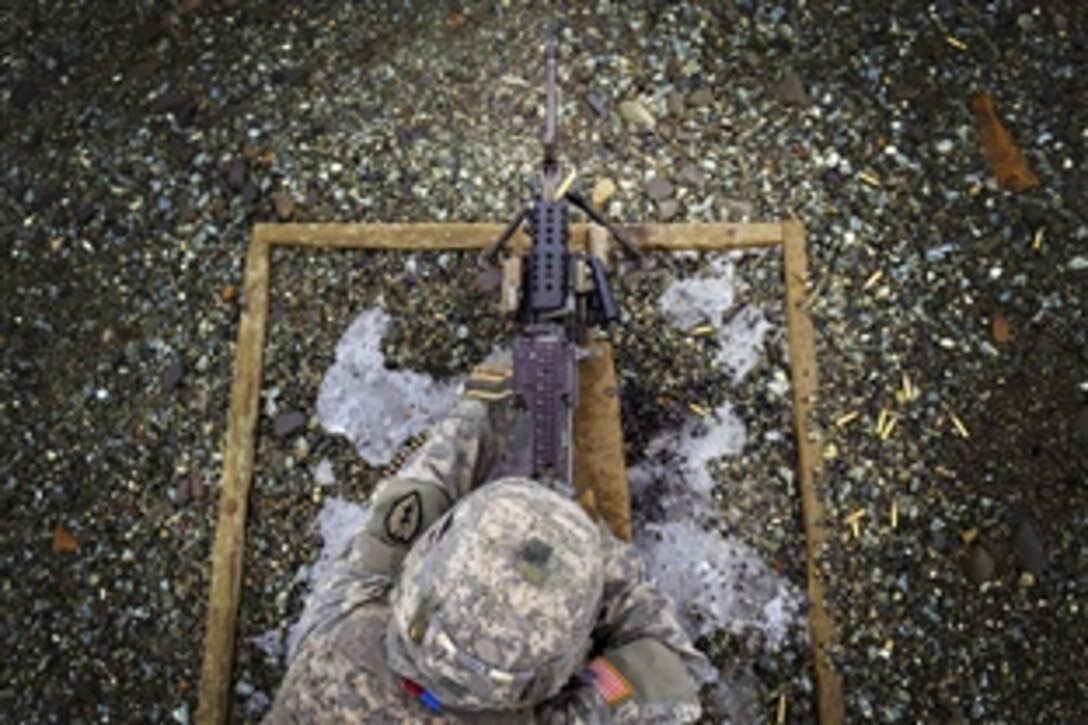 Army Spc. David Austin qualifies with the M249 squad automatic weapon on Joint Base Elmendorf-Richardson, Alaska, March 3, 2015. Austin is assigned to the 25th Infantry Division's Company A, 501st Infantry Regiment, 4th Infantry Brigade Combat Team Airborne. 
