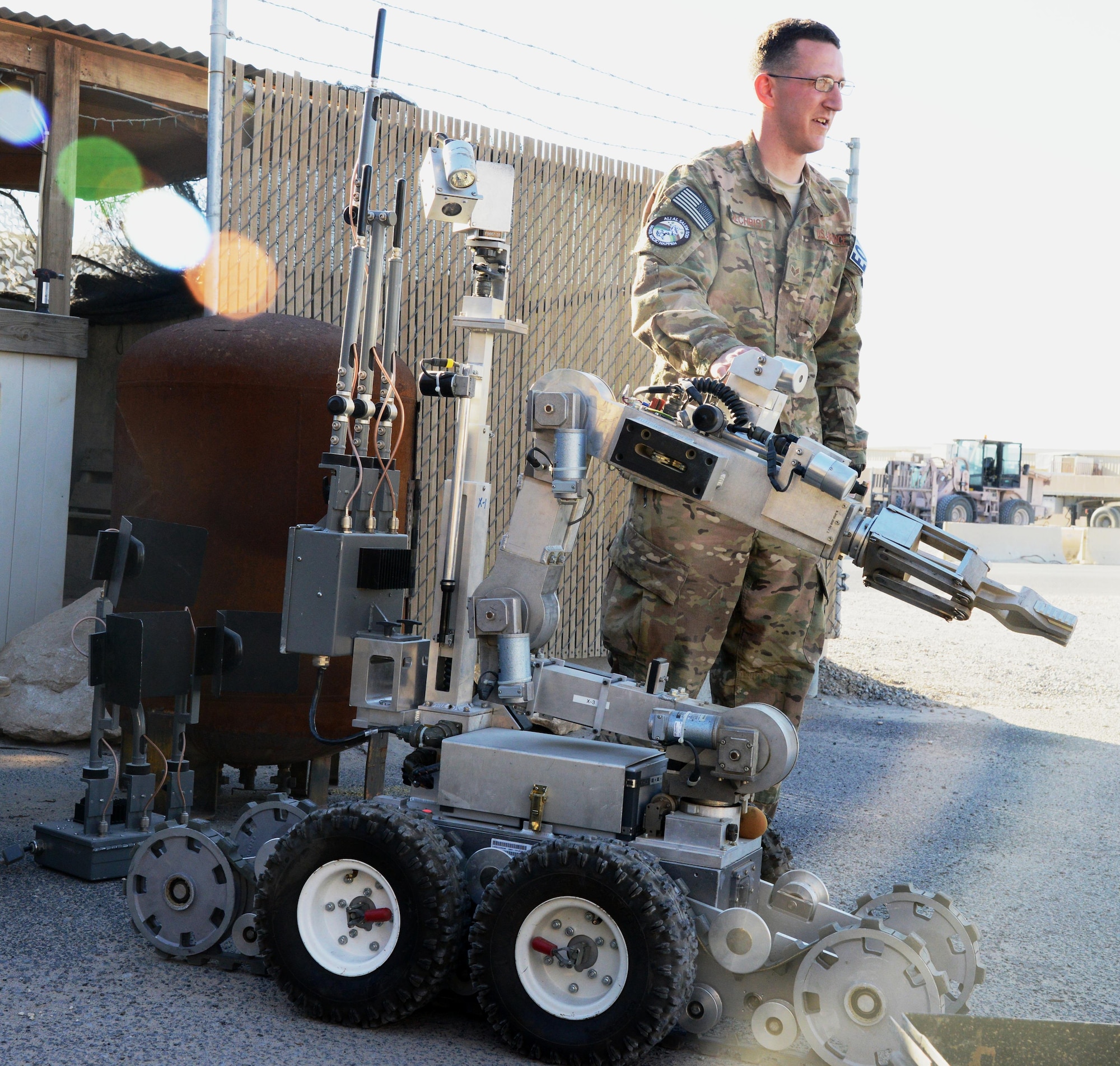 Senior Airmen Matthew Gilchrist, 386th Expeditionary Civil Engineer Squadron Explosive Ordnance Disposal technician, explains the capability and use of robots at an undisclosed location in Southwest Asia March 6, 2015.  EOD Airmen are responsible for locating and neutralizing potential explosive devices and often use robots to accomplish this from a safer distance. (U.S. Air Force photo by 1st Lt. Sarah Ruckriegle)