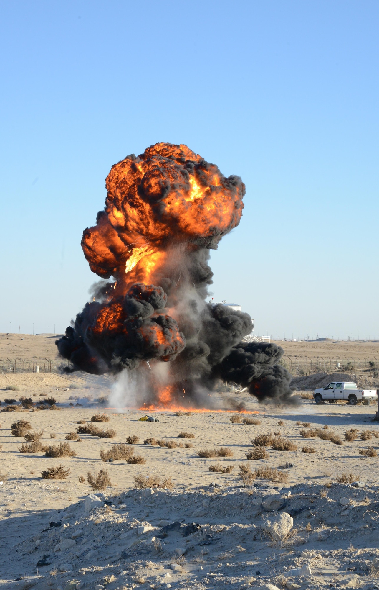 A plume of fire and smoke emerges from a controlled detonation conducted by 386th Expeditionary Civil Engineer Squadron Explosive Ordnance Disposal technicians at an undisclosed location in Southwest Asia March 6, 2015.  EOD Airmen perform controlled explosions as part of training and operations in order to dispose of unserviceable or unexploded munitions. EOD Airmen are also responsible for locating and neutralizing potential explosive devices, as well as clearing the airfield of hazardous munitions. (U.S. Air Force photo by 1st Lt. Sarah Ruckriegle)