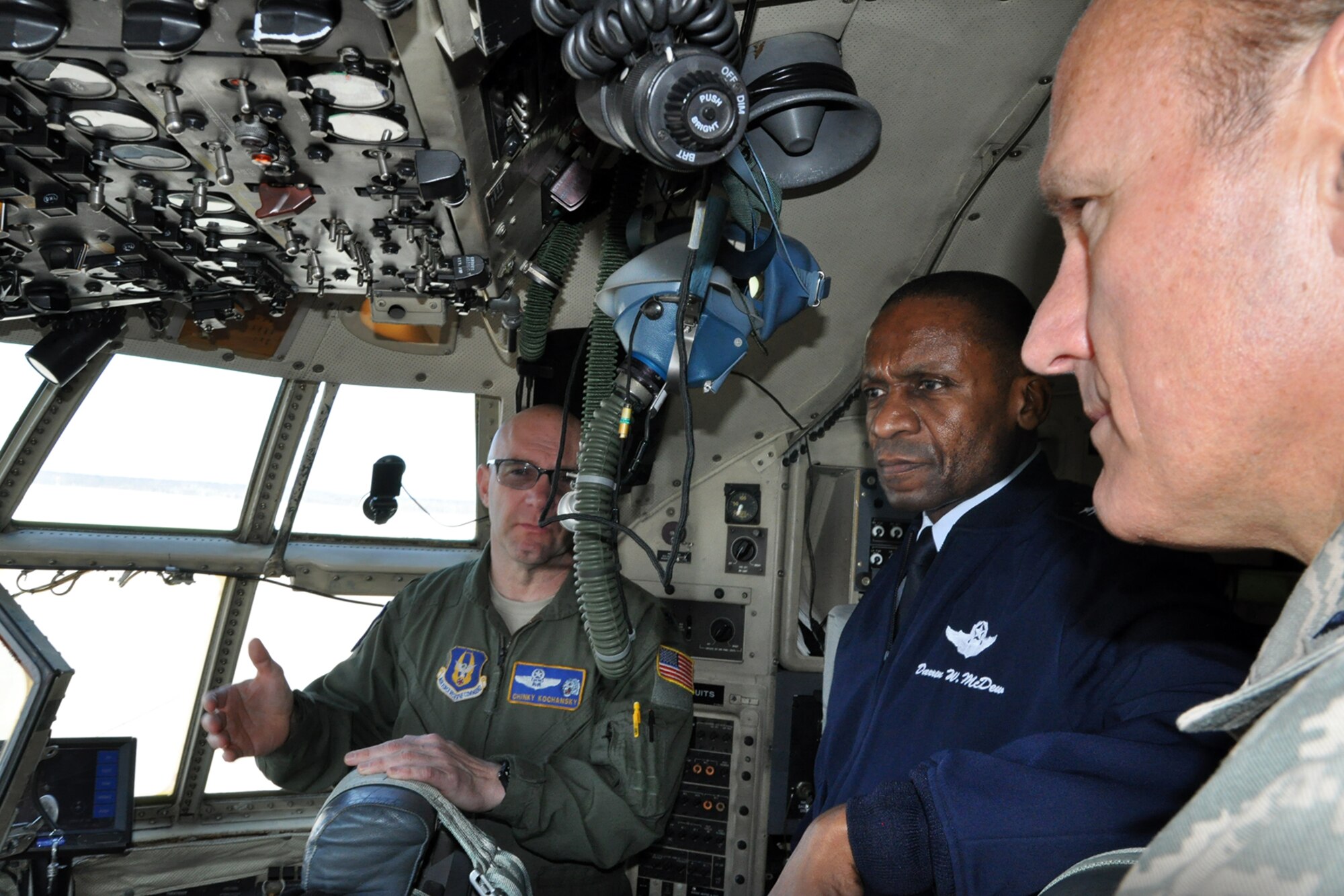 Air Force Reserve Lt. Col. John “Chinky” Kochansky, 910th Airlift Wing aerial spray flight chief, explains specialized aerial spray flight indicators to Air Mobility Command Commander Gen. Darren W. McDew, while 910th Vice Commander Col. Darryl Markowski listens on the flight deck of a modified C-130H Hercules aircraft here, March 9, 2015. McDew met with wing leadership and got a look at the 910th’s mission and capabilities. The 910th airlift Wing is home to the Department of Defense’s only large-area fixed-wing aerial spray capability. 