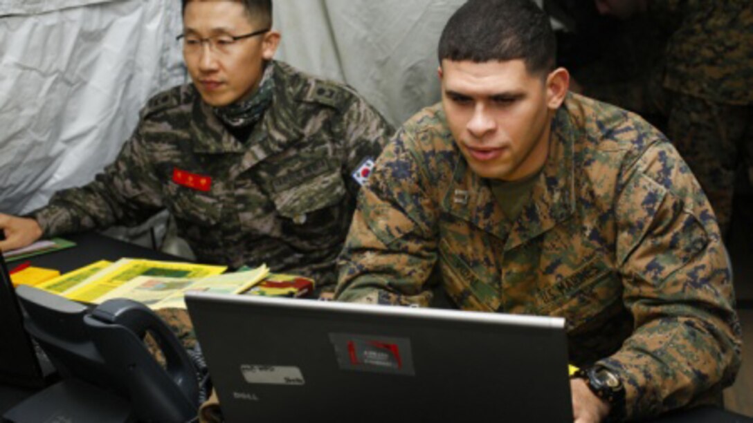 U.S. Marine Corps Capt. Elijah Vidal, New York, New York, III Marine Expeditionary Force Civil Affairs reports officer, works with Republic of Korea (ROK) Marine Maj. Seo Soo, ROK Marine Corps Headquarters reports officer, during Exercise Key Resolve 15 on Camp Mujuk, South Korea, March 10, 2015. Key Resolve is held annually to strengthen ROK-U.S. combat readiness and joint interoperability.