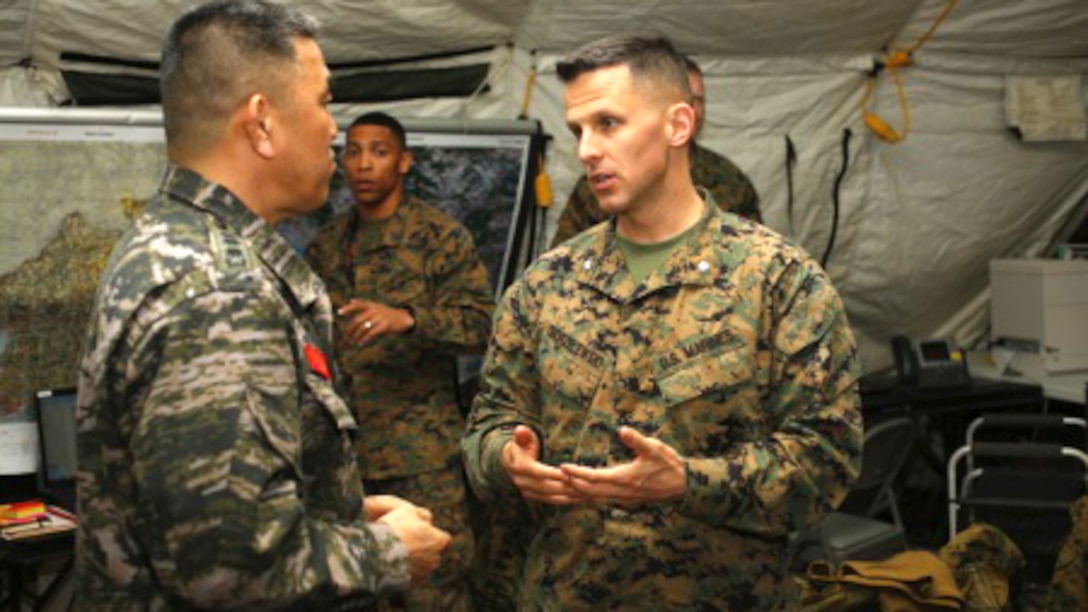 U.S. Marine Corps Lt. Col. Chad Chorzelewski, III Marine Expeditionary Force Deputy Force Fires coordinator, Cleveland, Ohio, talks with Republic of Korea (ROK) Marine Col. Jeon Byungdo, Marine Corps Fires Vice Chief, during Exercise Key Resolve 15 on Camp Mujuk, South Korea, March 10, 2015. Key Resolve is held annually to strengthen ROK-U.S. combat readiness and joint interoperability. 