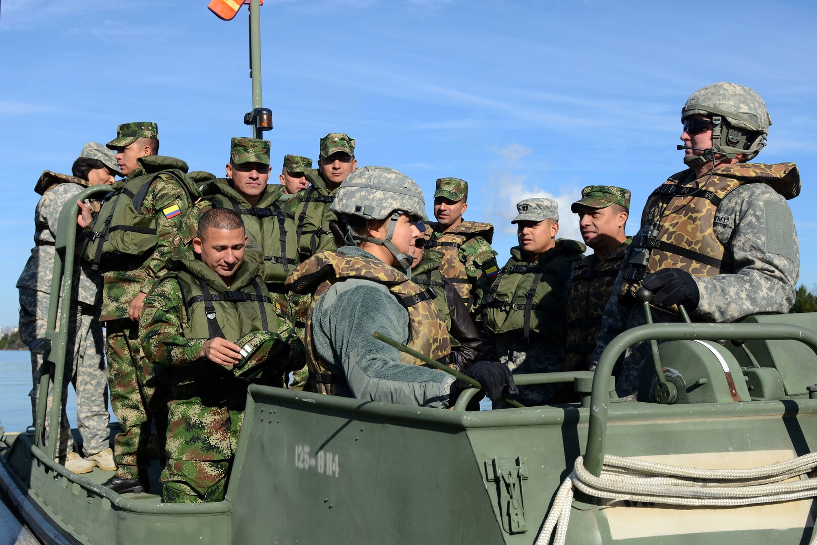 U.S. Army Spc. Caitlyn Causey, a medic assigned to the 122nd Engineering Company, left, and Staff Sgt. Jackie Rosier, a squad leader assigned to the 125th Multi-Role Bridge Company, right, prepare to take the Colombian military delegation to view the ferrying operation up-close via boat at the Carroll Ashmore Campbell Marine Complex, March 7, 2015, in Georgetown, South Carolina, as a part of the Vigilant Guard South Carolina exercise. Vigilant Guard is a series of federally funded disaster-response drills conducted by National Guard units working with federal, state and local emergency management agencies and first responders. 