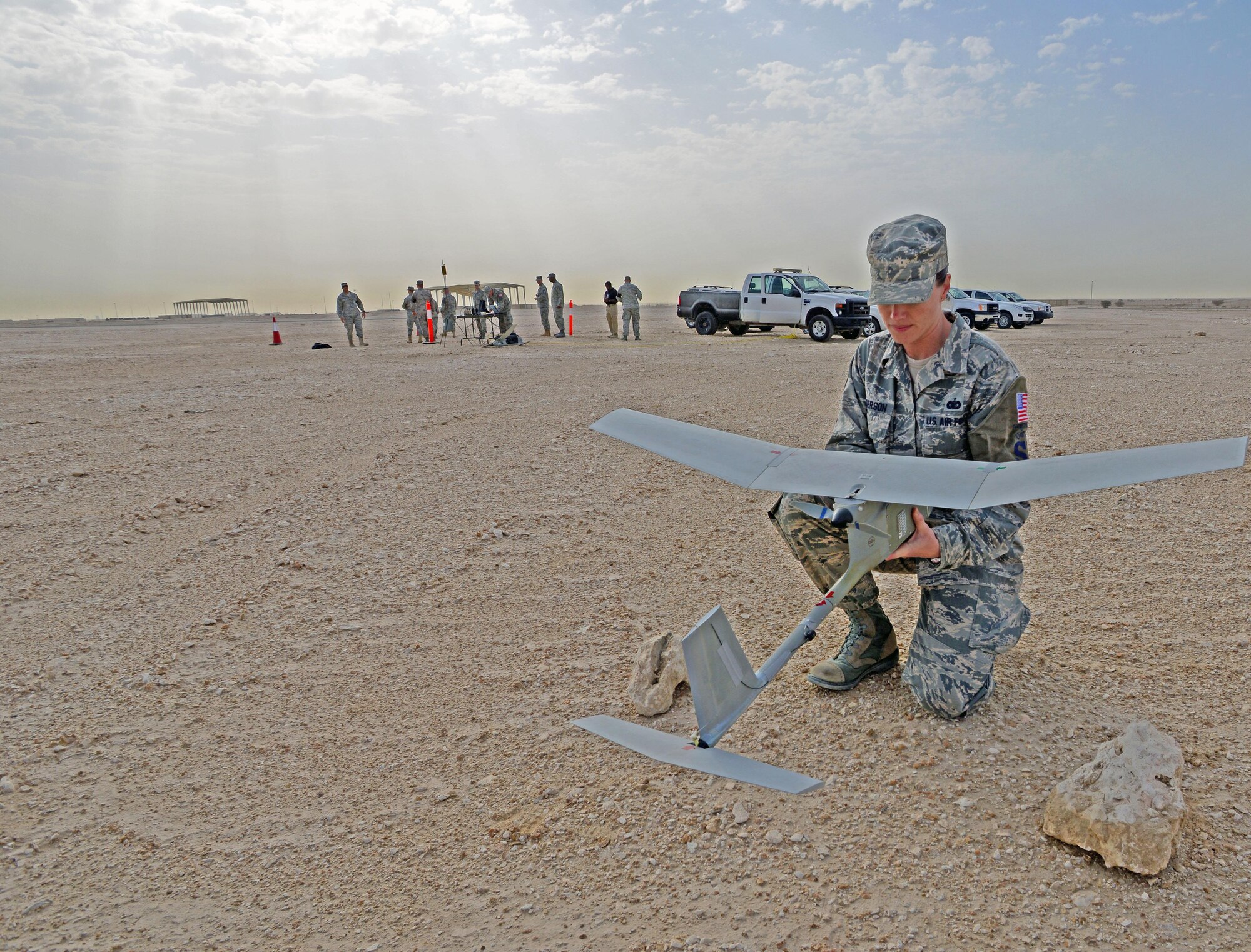 SSgt Elizabeth Henderson, 379th Expeditionary Security Forces Squadron, conducts pre-flight checks for an R-11B Raven at Al Udeid Air Base, Qatar, March 4, 2015, before an aerial demonstration for senior Qatari Air Force and 379th Air Expeditionary Wing leaders.  The RQ-11 Raven is a lightweight unmanned aircraft system that’s designed for rapid deployment and high-mobility for military operations. At Al Udeid, security forces Airmen use the Raven to support anti-terrorism measures like day or night aerial intelligence, surveillance, target acquisition, and reconnaissance. This is the first time since 2005 that the Raven has been used at Al Udeid. (Air Force photo by Master Sgt. Kerry Jackson) 