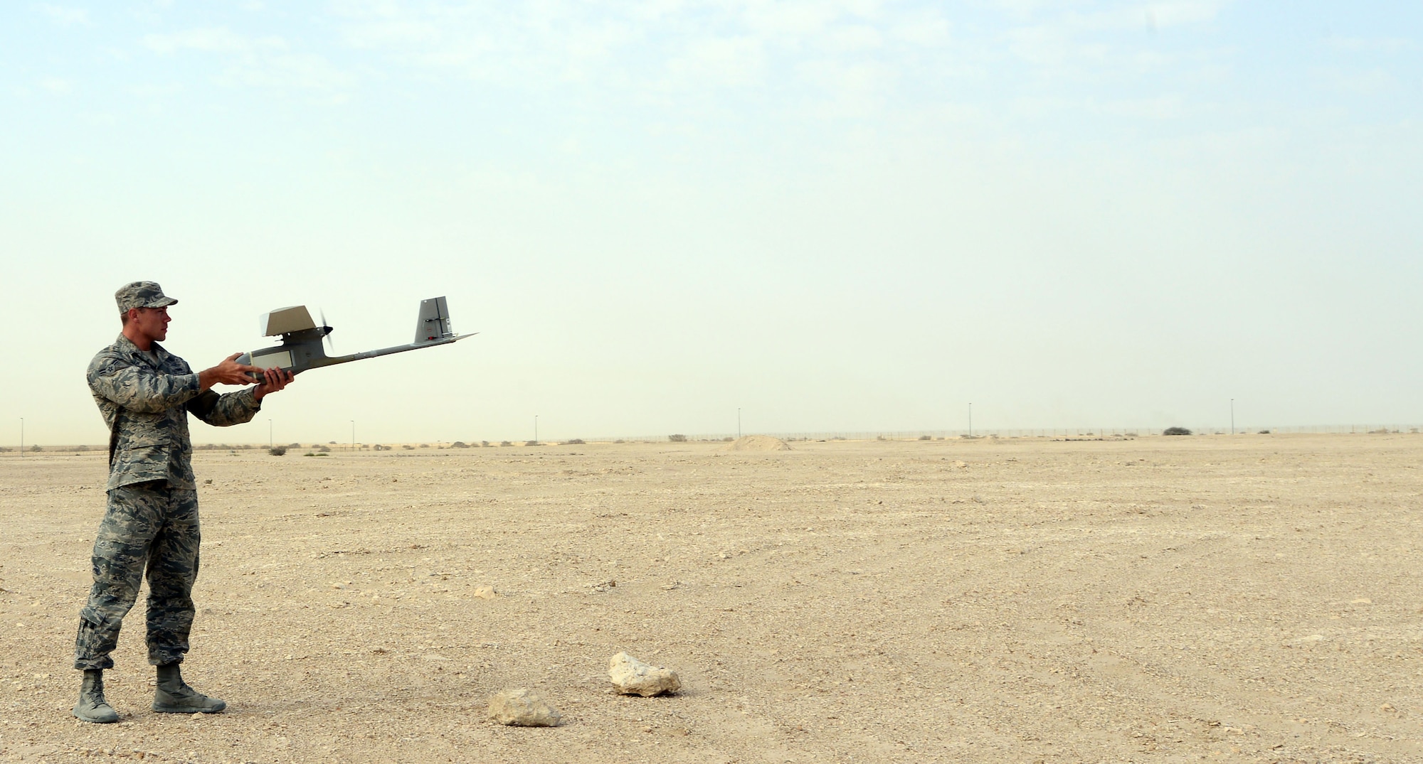 Airman Michael Puckett, 379th Expeditionary Security Forces Squadron, prepares to launch an R-11B Raven into the “wild blue yonder” during a demonstration for senior Qatari Air Force and 379th Air Expeditionary Wing leaders, Mar 4, 2015, at Al Udeid Air Base, Qatar.  The RQ-11 Raven is a lightweight unmanned aircraft system that’s designed for rapid deployment and high-mobility for military operations. At Al Udeid, security forces Airmen use the Raven to support anti-terrorism measures like day or night aerial intelligence, surveillance, target acquisition, and reconnaissance. This is the first time since 2005 that the Raven has been used at Al Udeid. (Air Force photo by Master Sgt. Kerry Jackson) 