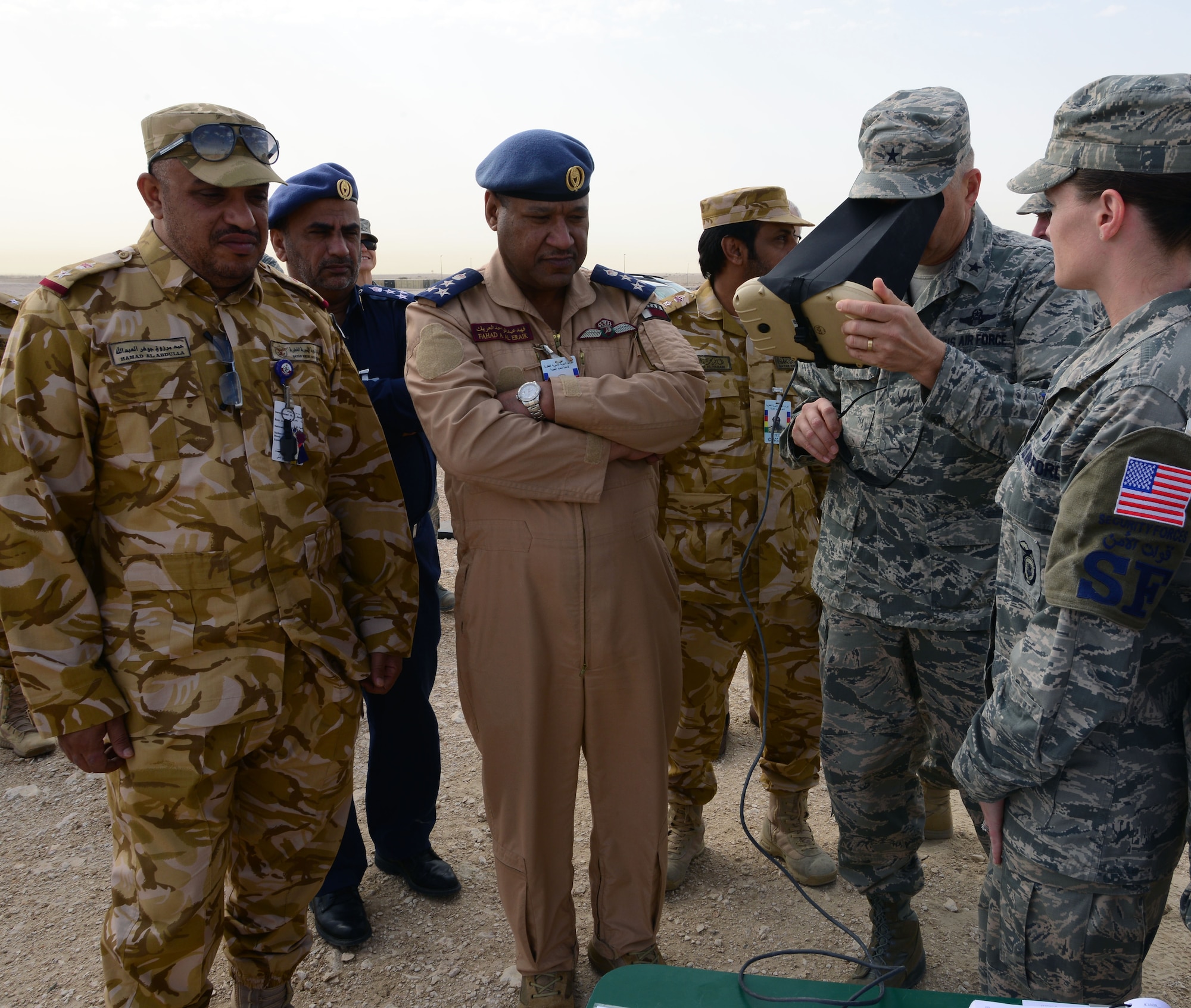 U.S. Air Force Brig. Gen. Darren Hartford (right), 379th Air Expeditionary Wing commander use remote hand controller to view real-time footage from an R-11B Raven during an aerial demonstration at Al Udeid AB, Qatar, March 4, 2015.  The RQ-11 Raven is a lightweight unmanned aircraft system that’s designed for rapid deployment and high-mobility for military operations. At Al Udeid, security forces Airmen use the Raven to support anti-terrorism measures like day or night aerial intelligence, surveillance, target acquisition, and reconnaissance. This is the first time since 2005 that the Raven has been used at Al Udeid. (Air Force photo by Master Sgt. Kerry Jackson) 