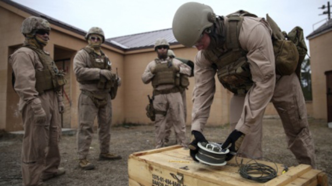 A Marine with 2nd Explosive Ordnance Disposal Company, 8th Engineer Support Battalion grabs a detonation system before his team moves to the dynamic entry course at a Military Operations in Urban Terrain exercise aboard Marine Corps Base Camp Lejeune, North Carolina, March 9, 2015. Marines with 2nd EOD have some hands on experience with explosive charges, and these sustainment training events can help them understand more clearly while working with other Marines who have more time training.