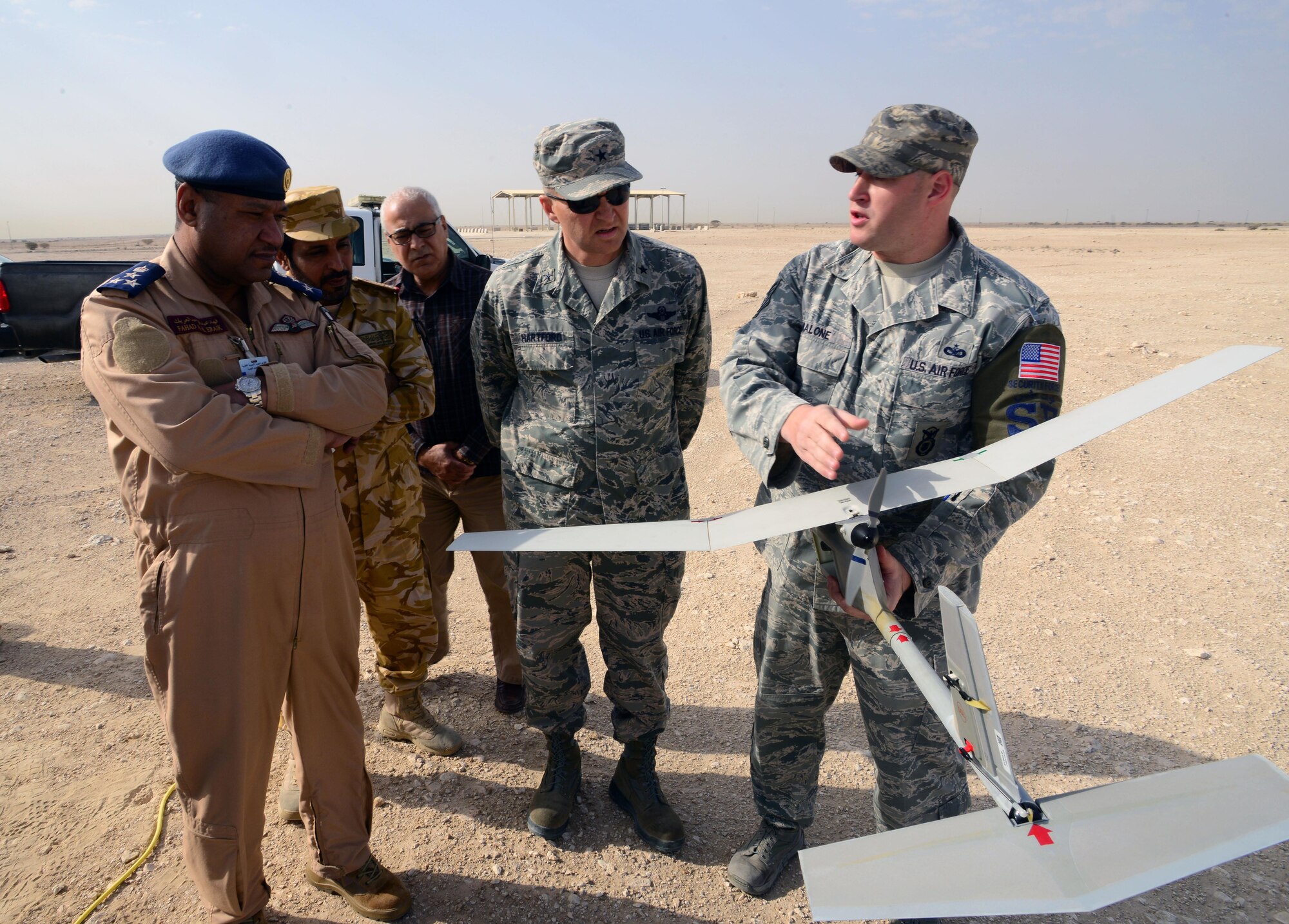 Tech. Sgt. Jeffery Malone, 379th Expeditionary Security Forces Squadron, briefs Qatari Brig. Gen.  Fahad Al-Eraik, the Al Udeid Air Base Commander and U.S. Air Force Brig. Gen. Darren Hartford, 379th Air Expeditionary Wing commander on the capability of the R-11B Raven during an aerial demonstration at Al Udeid AB, Qatar, March 4, 2015.  The RQ-11 Raven is a lightweight unmanned aircraft system that’s designed for rapid deployment and high-mobility for military operations. At Al Udeid, security forces Airmen use the Raven to support anti-terrorism measures like day or night aerial intelligence, surveillance, target acquisition, and reconnaissance. This is the first time since 2005 that the Raven has been used at Al Udeid. (Air Force photo by Master Sgt. Kerry Jackson) 