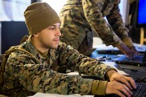 Lance Cpl. Victor Reyes, a general clerk with Combat Logistics Regiment 2, 2nd Marine Logistics Group, works on his computer during a command post exercise aboard Marine Corps Base Camp Lejeune, N.C., March 6, 2015. The command post exercise was implemented to ensure that when participating in Exercise African Lion 15, the Marines of CLR-2 maintain readiness to accomplish their mission with minor setbacks along the way. (U.S. Marine Corps photo by Cpl. Krista James/Released)