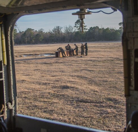 Marines with Combat Logistics Battalion 6, 2nd Marine Logistics Group, attach chains to an 8,500 pound metal beam before a CH-53 Super Stallion helicopter uses either single or dual point hooks to lift the load off the ground aboard Marine Corps Base Camp Lejeune, N.C., March 4, 2015. Marine Heavy Helicopter Training Squadron 302, Marine Aircraft Group 29, 2nd Marine Air Wing teamed up with CLB-6 to conduct external-lift exercises. The training allowed the pilots to work hand-in-hand with groundside Marines in an effort to support II Marine Expeditionary Force’s readiness.