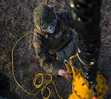 A Marine with Combat Logistics Battalion 6, 2nd Marine Logistics Group, uses a shepard’s hook to ground a single point claw during externallift exercises aboard Camp Lejeune, N.C., March 4, 2015. CLB-6 teamed up with Marine Heavy Helicopter Training Squadron 302, Marine Aircraft Group 29, 2nd Marine Air Wing to execute external-lifts where a CH-53 Super Stallion helicopter simulates extracting and inserting 8,500 pounds of supplies. The training allowed the pilots to work hand-in-hand with groundside Marines in an effort to support II Marine Expeditionary Force’s readiness.