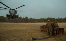 Marines with Combat Logistics Battalion 6, 2nd Marine Logistics Group attach chains to an 8,500 lbs. metal beam before a CH-53 Super Stallion helicopter uses a single and dual point hooks to lift the load off the ground aboard Camp Lejeune, N.C., March 4, 2015. Marine Heavy Helicopter Training Squadron 302, Marine Aircraft Group 29, 2nd Marine Air Wing teamed up with CLB-6 to conduct external lift exercises. The training allowed the pilots to work hand-in-hand with groundside Marines in an effort to support II Marine Expeditionary Force’s readiness.