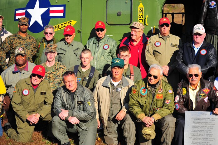 Vietnam Veterans and current Marines pose for a group photos in front of a UH-34D Helicopter. This helicopter was the first rotary wing air frame flown in Vietnam. The helicopter will become part of the National Museum of the Marine Corps Vietnam exhibit. 