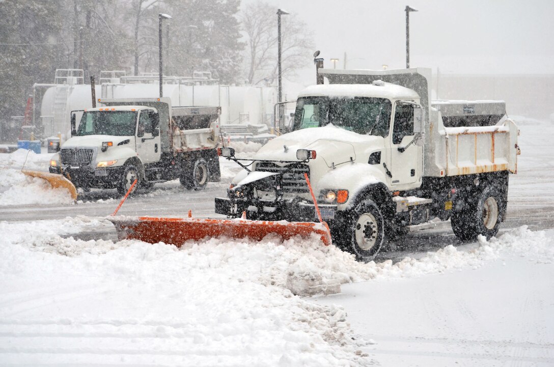 Snow plows clear the parking lot at the Marine Corps Base Quantico base motor pool on March 5 to ensure the smooth flow of snow removal operations for the rest of the day and in preparation for regular activity on Friday. 
