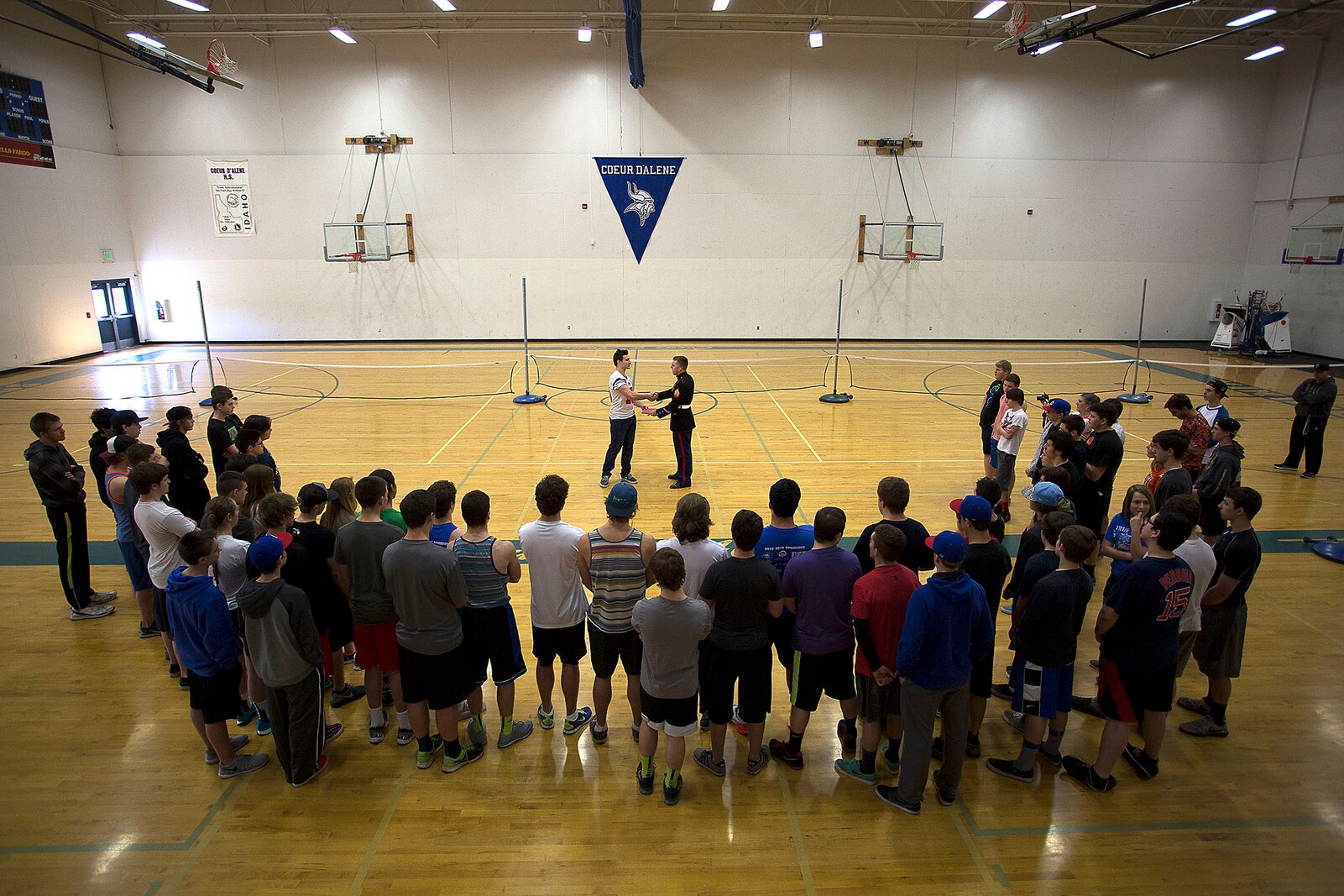 Sgt. Alex Angle (right), a Marine recruiter in Hayden, Idaho, congratulates Coeur d’Alene High School student athlete Drew Berger on his participation in the Semper Fidelis All-American Bowl during a school visit March 12, 2015. Berger, a highly touted linebacker from Coeur d’Alene, Idaho, was the lone Idaho football player selected to play in the Jan. 4 game in Carson, California. Following his high school graduation, Berger will attend Boise State University on an athletic scholarship. (U.S. Marine Corps photo by Sgt. Reece Lodder)