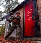 Cpl. Derek Michael, a combat engineer with 8th Engineer Support Battalion, 2nd Marine Logistics Group, 2nd Marine Expeditionary Force utilizes a battering ram to gain entry inside a room at Engineer Training Area 1 aboard Marine Corps Base Camp Lejeune, N.C., Feb. 10, 2015. The battering ram causes the bolts on the door to break after being struck several times.