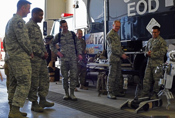 Chief Master Sgt. of the Air Force James Cody (center right) controls a robot used by a explosive ordnance disposal team March 9, 2015, during a tour of the Malmstrom Air Force Base, Mont. Cody learned how EOD members use robotic platforms to capture and destroy improvised explosive devices. (U.S. Air Force photo/Airman 1st Class Collin Schmidt)