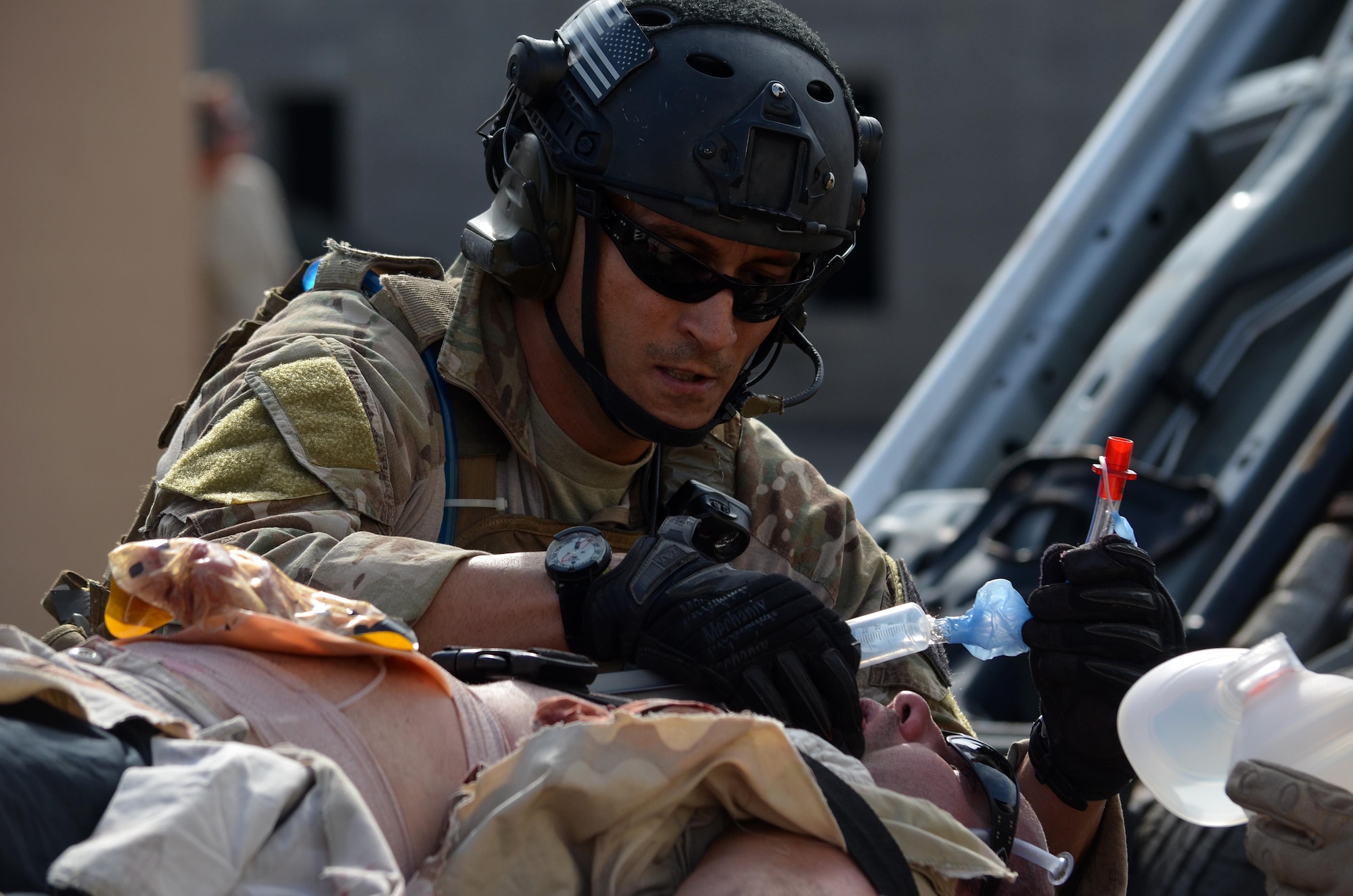 MSgt. Christopher Lais, 308th Rescue Squadron, administers care to a vehicle-borne improvised explosive victim during a mass casualty training exercise conducted March 10, 2015 in Perry, GA. This four-day exercise used HH-60 Pave Hawks and MV-22 Ospreys for simulated scenarios that included earthquake collapsed buildings, vehicle-borne improved explosive devices detonating, and mass casualty response. (U.S. Air Force photo/Staff Sgt. Kelly Goonan)