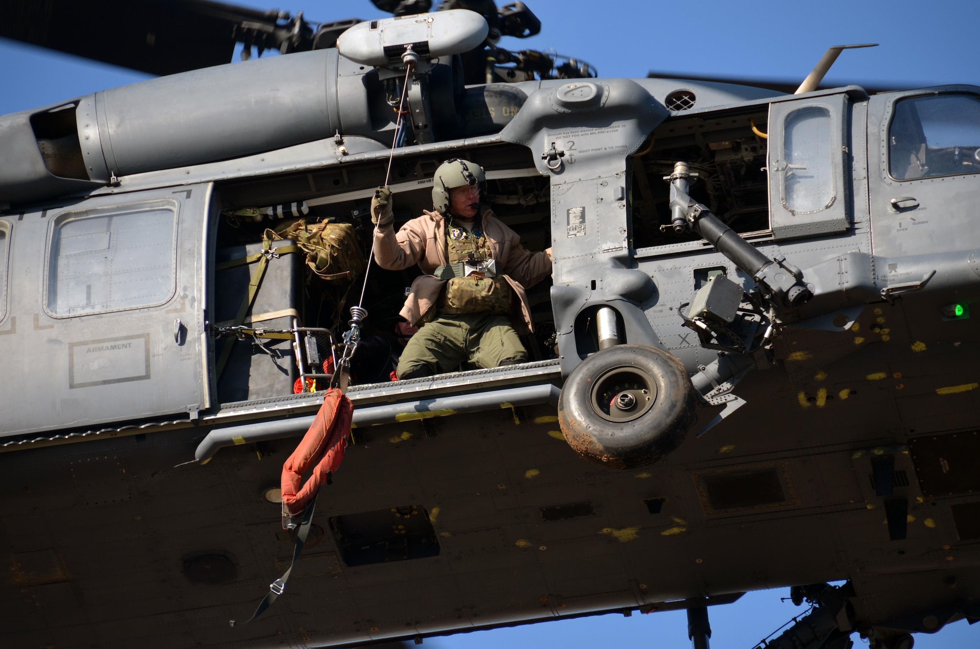 SMSgt. John Louden, 301st Rescue Squadron, prepares to lower a rescue strop as the HH-60 Pave Hawk positions above a rooftop during Katrina-like flood training March 8, 2015 in Perry, GA. This four-day exercise used HH-60 Pave Hawks and MV-22 Ospreys for simulated scenarios that included earthquake collapsed buildings, vehicle-borne improved explosive devices detonating, and mass casualty response. (U.S. Air Force photo/Staff Sgt. Kelly Goonan)