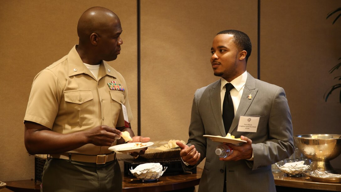 Lt. Col. Christopher Shaw, legal advisor to the secretary of the navy, speaks with a National Black Law Student Association member during the NBLSA convention here, today. NBLSA is a national organization formed to articulate and promote the needs and goals of minority law students.