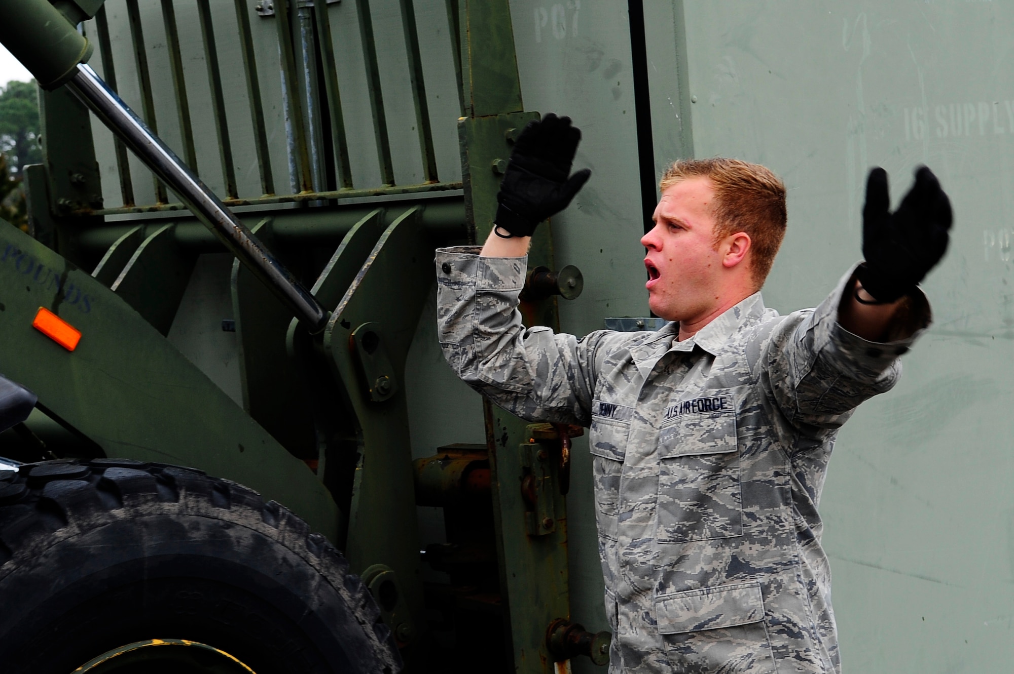 Airman Mitchel Denny, 1st Special Operations Logistics Readiness Squadron vehicle operations, directs a 10 K all terrain fork lift at Hurlburt Field, Fla., Feb 24, 2015. Vehicle Operations Flight provides transportation services on demand for Hurlburt Field to include Distinguished Visitor support, base taxi, flight line operations and cargo pick-up and delivery services, and government driver's license issue. (U.S. Air Force photo/Airman 1st Class Andrea Posey)