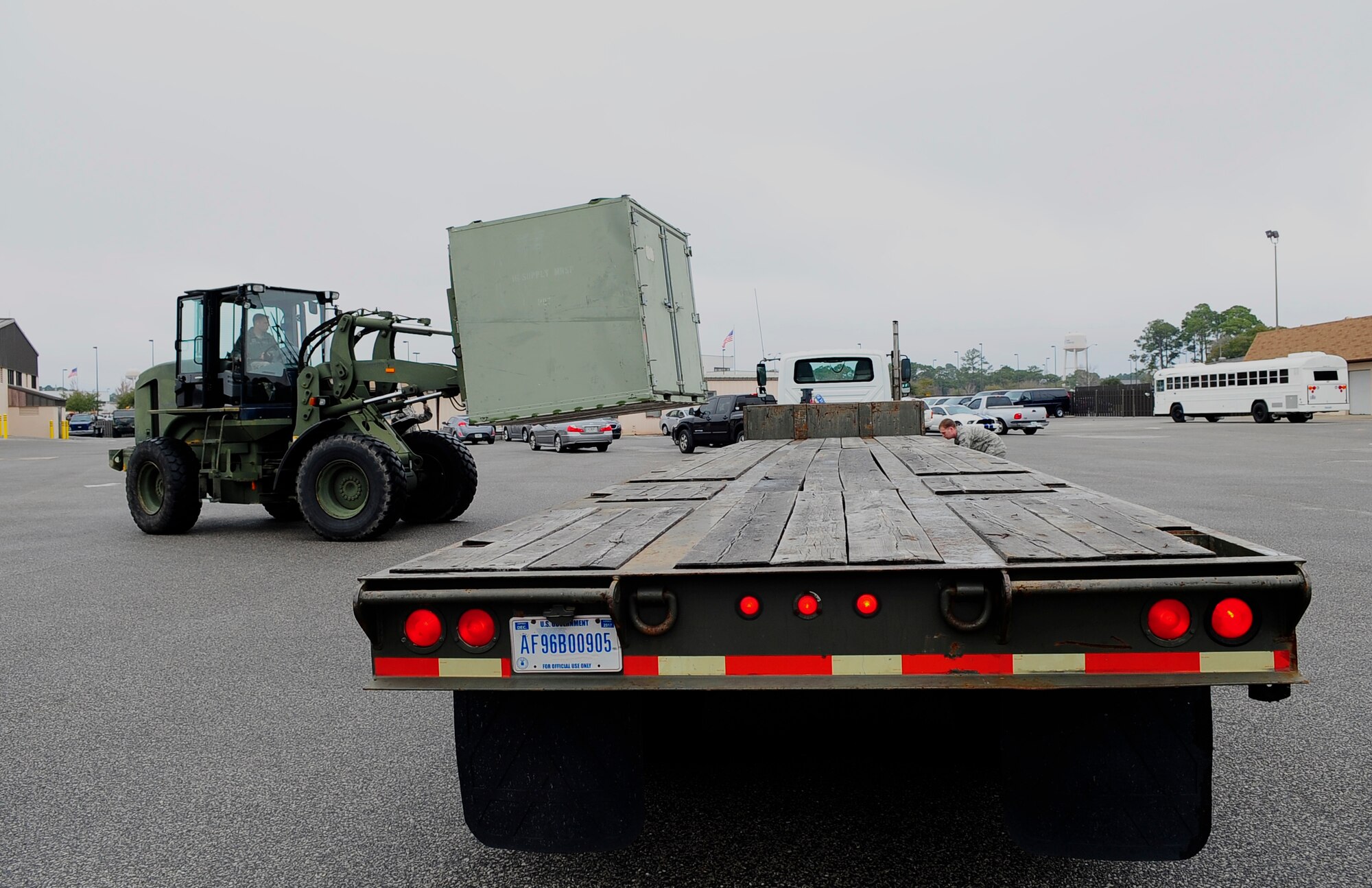 Senior Airman Tristan Roberts, 1st Special Operations Logistics Readiness Squadron vehicle operations, loads a crate onto a tractor trailer at Hurlburt Field, Fla., Feb 24, 2015.  Vehicle Operations Flight provides transportation services on demand for Hurlburt Field to include Distinguished Visitor support, base taxi, flight line operations and cargo pick-up and delivery services, and government driver's license issue. (U.S. Air Force photo/Airman 1st Class Andrea Posey)