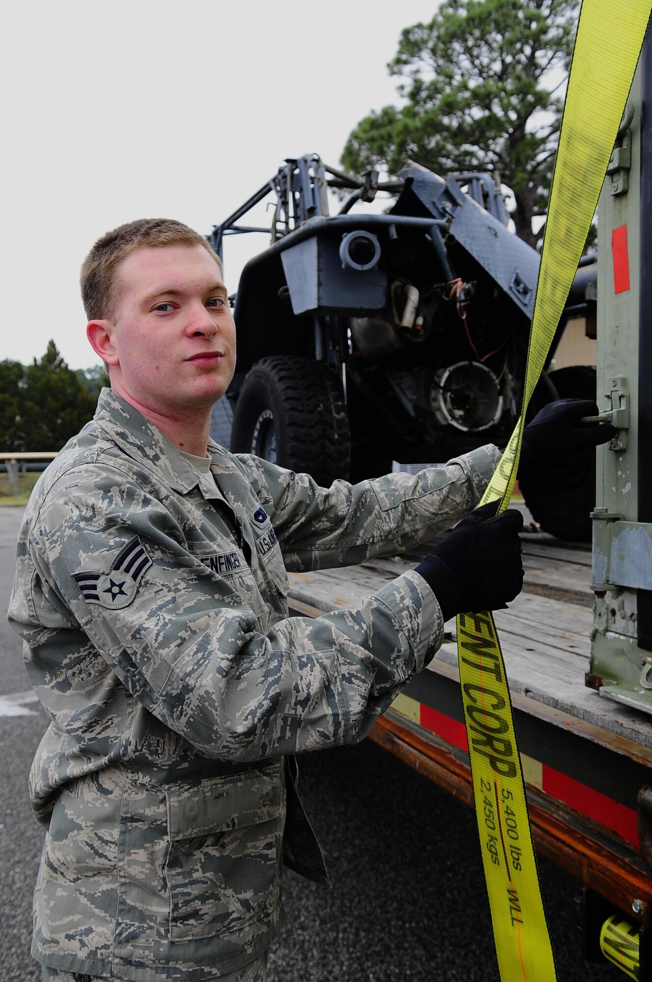 Senior Airman Tyler Enfinger, 1st Special Operations Logistics Readiness Squadron vehicle operations, secures equipment to a trailer at Hurlburt Field, Fla., Feb 24, 2015. Vehicle Operations Flight provides transportation services on demand for Hurlburt Field to include Distinguished Visitor support, base taxi, flight line operations and cargo pick-up and delivery services, and government driver's license issue. (U.S. Air Force photo/Airman 1st Class Andrea Posey)