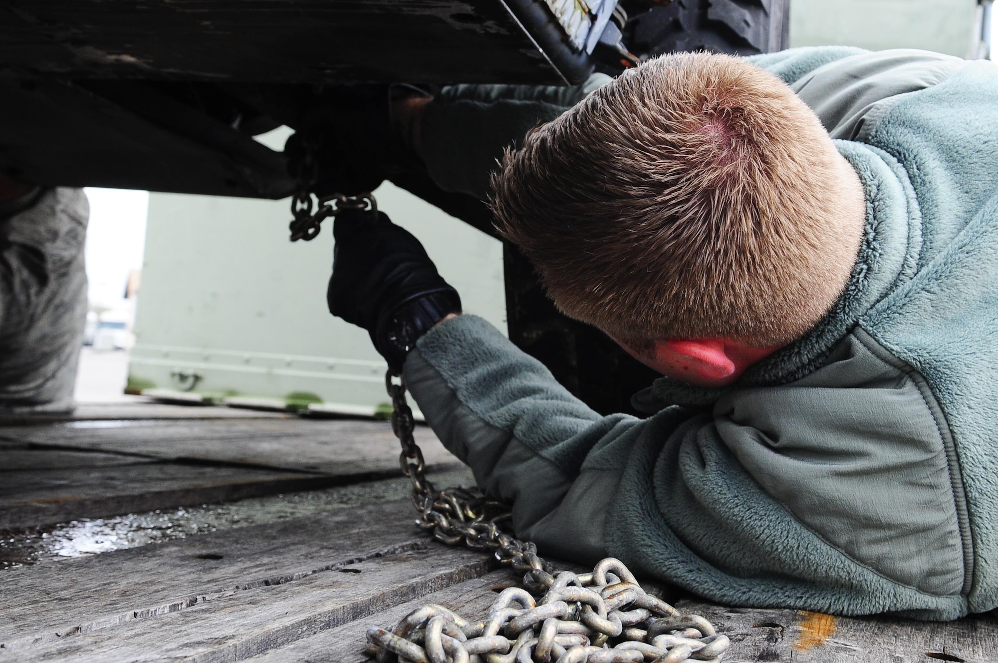 Senior Airman Tristan Roberts, 1st Special Operations Logistics Readiness Squadron vehicle operations, secures a vehicle to a trailer at Hurlburt Field, Fla., Feb 24, 2015. Vehicle Operations Flight provides transportation services on demand for Hurlburt Field to include Distinguished Visitor support, base taxi, flight line operations and cargo pick-up and delivery services, and government driver's license issue. (U.S. Air Force photo/Airman 1st Class Andrea Posey)