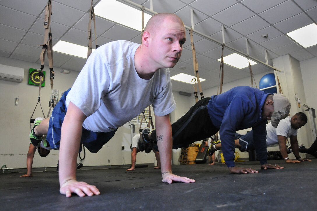 Tech Sgt. Matt B. Halstead, 94th Civil Engineer Squadron  explosive ordnance disposal, performs pushups during a TRX Suspension Training program held March 7, 2015 at Dobbins’ Human Performance Center. TRX is a workout system developed by a U.S. Navy Seal and uses suspension straps and different movements to create a full-body workout . (U.S. Air Force photo/Senior Airman Andrew J. Park)