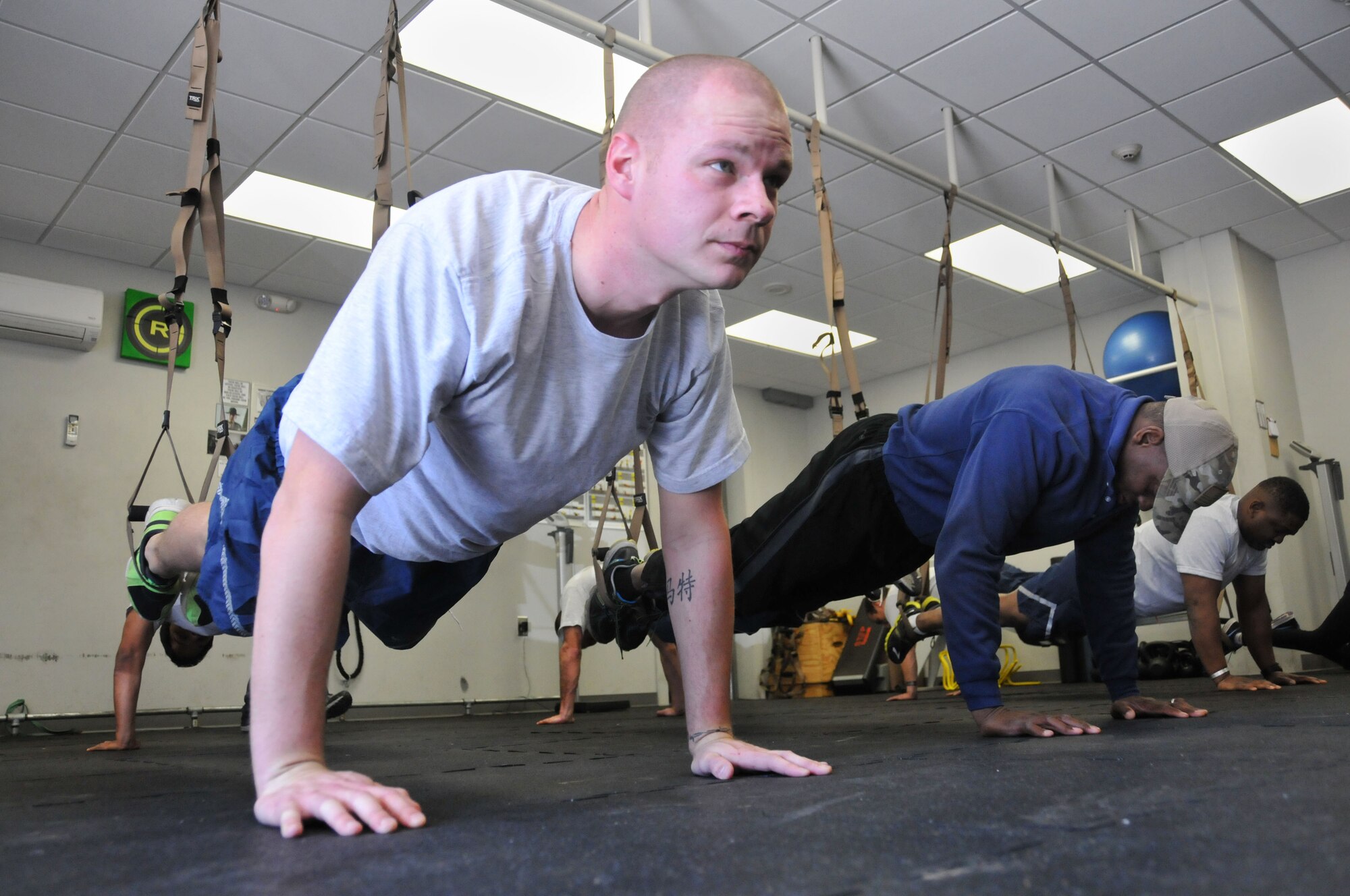 Tech Sgt. Matt B. Halstead, 94th Civil Engineer Squadron  explosive ordnance disposal, performs pushups during a TRX Suspension Training program held March 7, 2015 at Dobbins’ Human Performance Center. TRX is a workout system developed by a U.S. Navy Seal and uses suspension straps and different movements to create a full-body workout . (U.S. Air Force photo/Senior Airman Andrew J. Park)