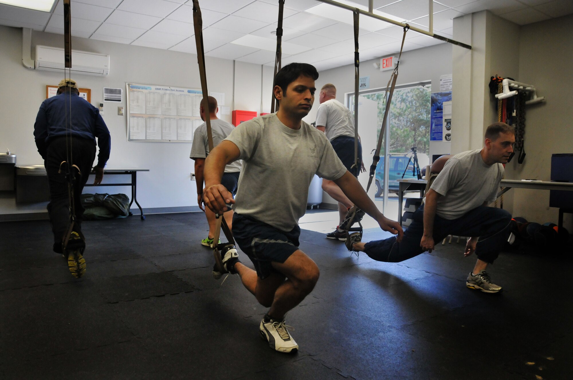 Staff Sgt. Juan S. Ortiz, 94th Civil Engineer Squadron  explosive ordnance disposal, performs a single-leg squat as part of the TRX program Mar. 7, 2015 at Dobbins’ Human Performance Center. TRX includes upper and lower-body exercises  to simultaneously build body strength, increase flexibility and strengthen core muscles. (U.S. Air Force photo/Senior Airman Andrew J. Park)