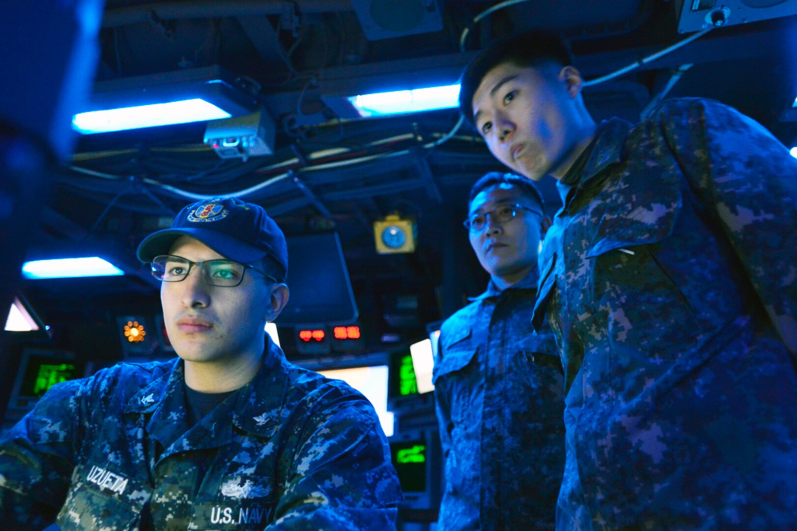 In this file photo, Information Systems Technician 3rd Class Damonique Uzueta monitors operations in Combat Information Control, as Republic of Korea Navy Lt. j.g. Woo Sung Hwa and Chief Petty Officer Lee Moon Hoe observe, while underway aboard the guided-missile destroyer USS John S. McCain (DDG 56) during Exercise Foal Eagle 2015. McCain is on patrol in the 7th Fleet area of responsibility supporting security and stability in the Indo-Asia-Pacific region. Foal Eagle is a series of annual training events that are defense-oriented and designed to increase readiness and maintain stability on the Korean Peninsula while strengthening the ROK-U.S. alliance and promoting regional peace and stability of the Indo-Asia-Pacific region. 
