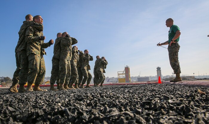 Recruits of India Company, 3rd Recruit Training Battalion, perform a counter to the rear choke during the Marine Corps Martial Arts Program test at Marine Corps Recruit Depot San Diego, Feb. 18.  Recruits were required to show confidence and no hesitation in the execution of a technique or the instructor would make them try again individually. If unsuccessful, he would receive an “X” on his score card, indicating he failed the technique.