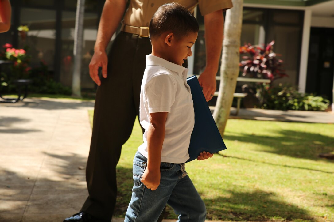 Three-year-old Miles Joseph mimics his father's marching after an award ceremony March 13, 2015, at the Naval health Clinic Hawaii, aboard Joint Base Pearl Harbor Hickam. The American Heart Association recognized Mile's father, Sgt. Michael Joseph, an avionics technichian wiht Marine Light Attack Helicopter Squadron 367, for saving a fellow Marine's life. Joseph performed CPR before paramedics came to the Marine's aid. Because of Joseph's actions, the Marine is expected to make a full recovery. (U.S. Marine Corps photo by Sgt. Sarah Dietz)