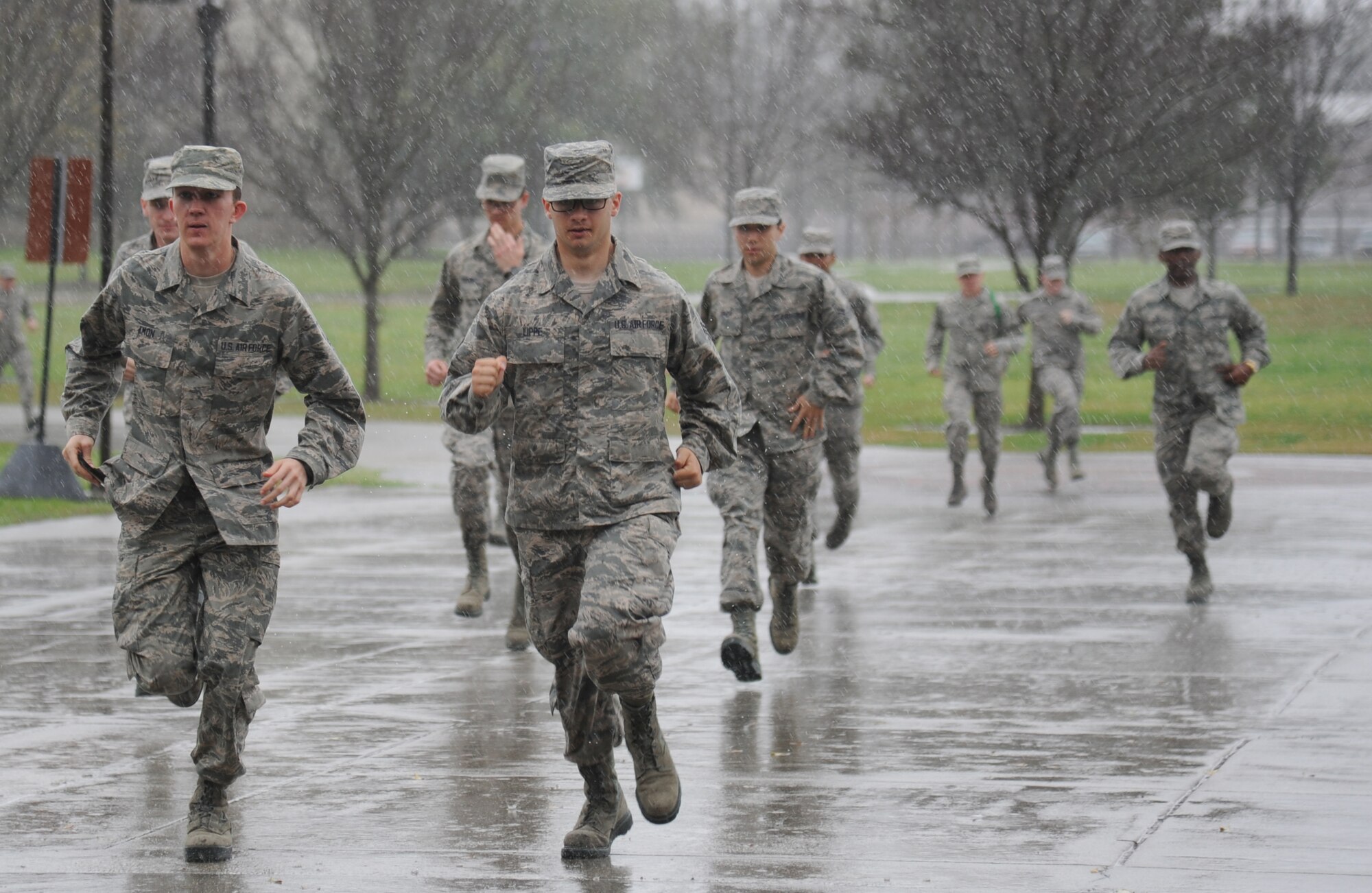 Airmen in the 335th Training Squadron run from Davis Manor to Connor Manor while transitioning between training stations during an “Introduction to Mobility” training day for non-prior service Airmen March 13, 2015, at Keesler Air Force Base, Miss.  Airmen participated in pre-deployment training scenarios such as: going through a mobility processing line, administering self-aid and buddy care, reviewing the steps for chemical warfare gear and receiving a pre-deployment briefing.  The training was conducted to better prepare Keesler’s Airmen for deployment operations. (U.S. Air Force photo by Kemberly Groue)