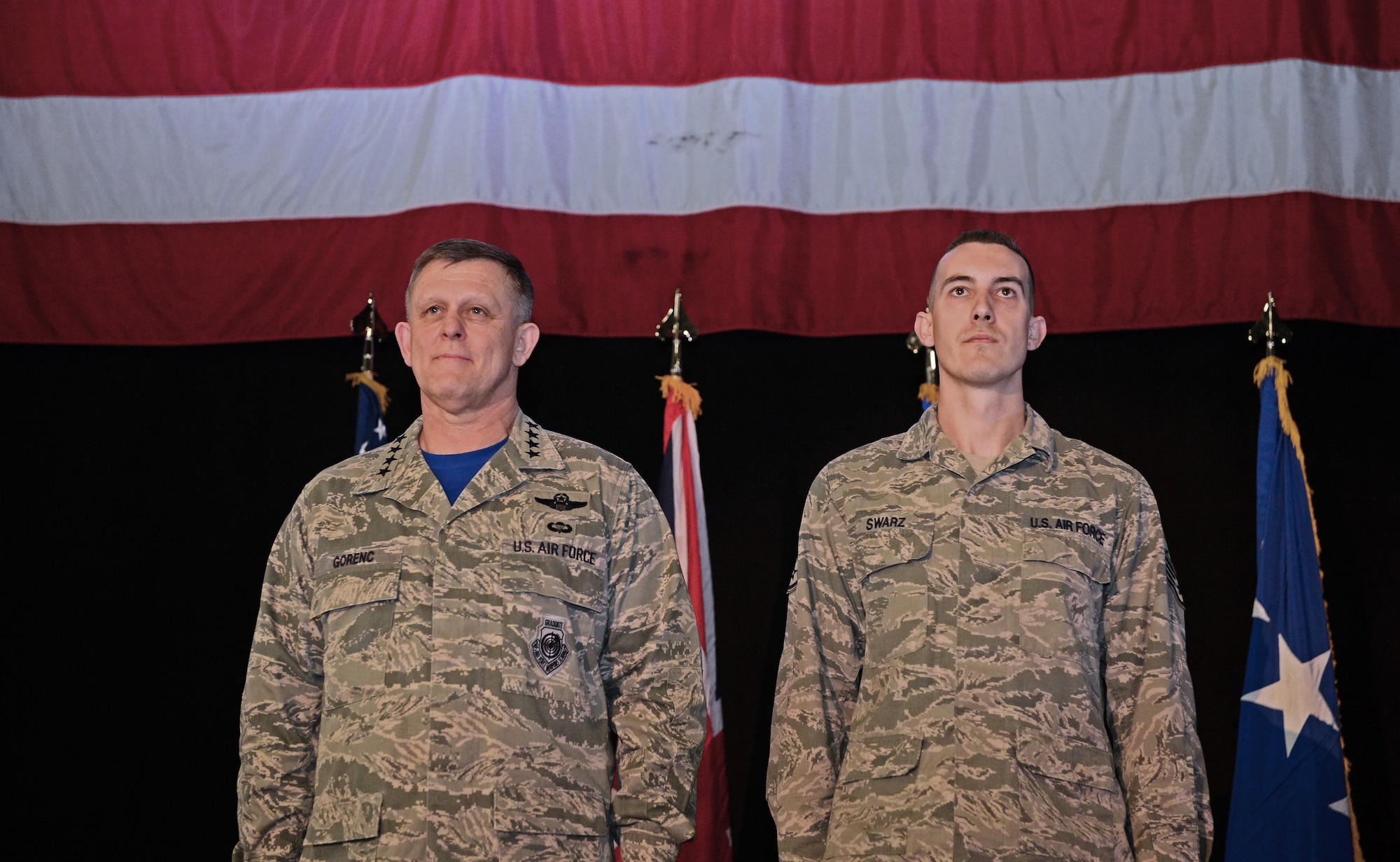Gen. Frank Gorenc, U.S. Air Forces in Europe and Air Forces Africa commander, and Staff Sgt. Greggory Swarz, 492nd Aircraft Maintenance Unit electrical environmental systems specialist, stand at attention during Swarz’s Airman’s Medal presentation at Royal Air Force Lakenheath, England, March 13, 2015. Swarz was recognized for his heroic actions on Jan. 26, 2015, when he saved the lives of three French airmen after a Hellenic Air Force F-16 crashed into the parking ramp at Los Llanos Air Base, Spain, during Tactical Leadership Program 15-1. (U.S. Air Force photo by Airman 1st Class Dawn Weber/Released)