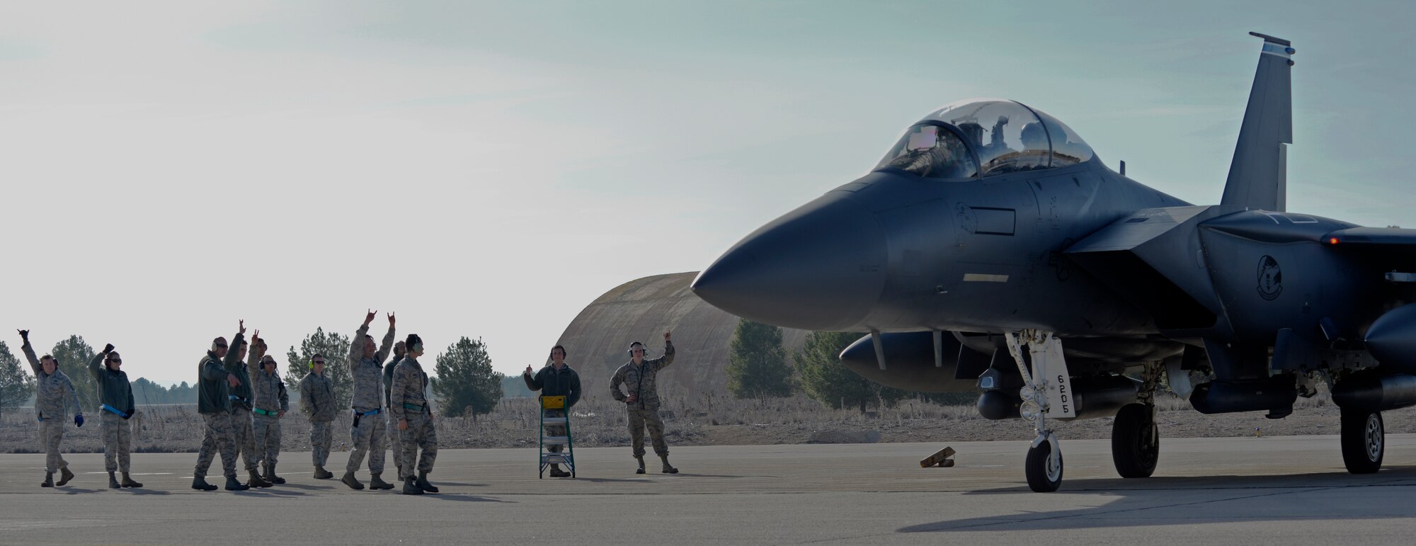 Liberty Airmen from the 492nd Aircraft Maintenance Unit and the 492nd Fighter Squadron bid their comrades farewell, as they prepare for departure in an F-15E Strike Eagle at Los Llanos Air Base, Spain, Jan. 29, 2015. The 492nd FS was in Spain for Tactical Leadership Program 15-1, which was cut short due to an aircraft crash on Jan. 26, 2015. (U.S. Air Force photo by Airman 1st Class Erin R. Babis/Released)