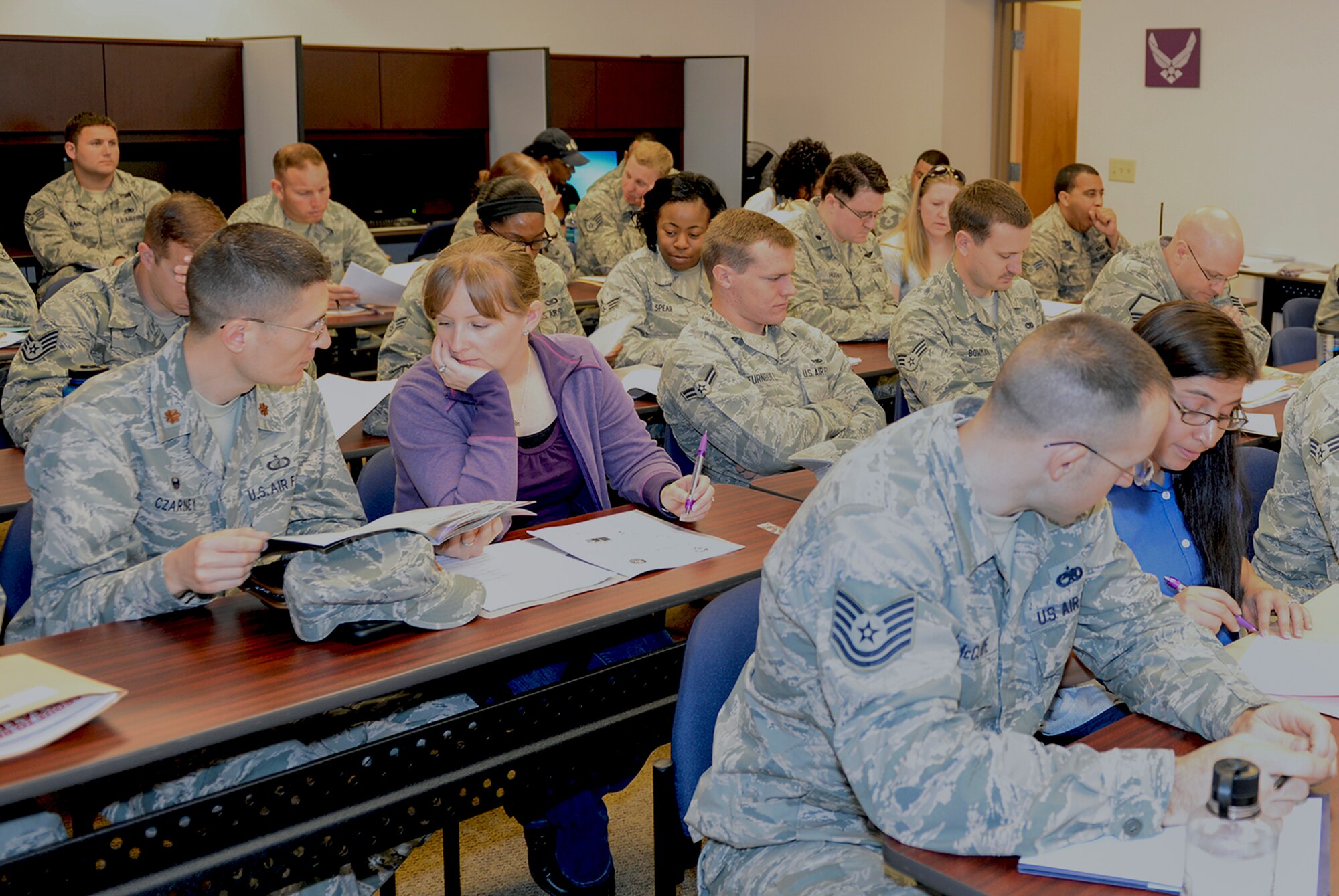 Airmen and family members attend a Smooth Move briefing March 11, 2015, at Moody Air Force Base, Ga. The briefing taught Airmen how to prepare for a smooth permanent change of station. (U.S. Air Force photo by Airman Greg Nash/Released)