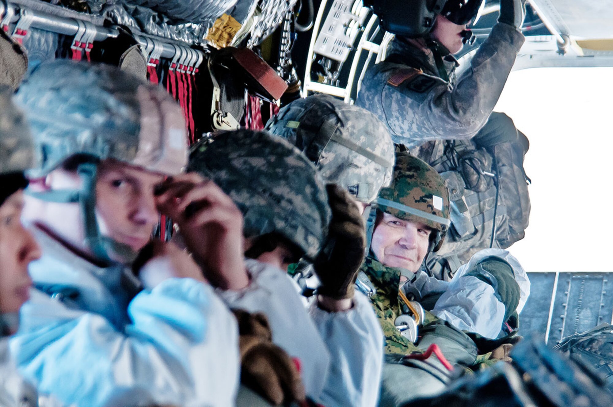 Master Gunnery Sgt. Jon Lines (right), an intelligence chief with the 3rd Marine Division out of Okinawa, Japan, prepares for a jump at JBER March 5. Lines visited the 4th Infantry Brigade Combat Team (Airborne), 25th Infantry Division, to build an exchange program. (U.S. Army photo/Sgt. Eric-James Estrada)