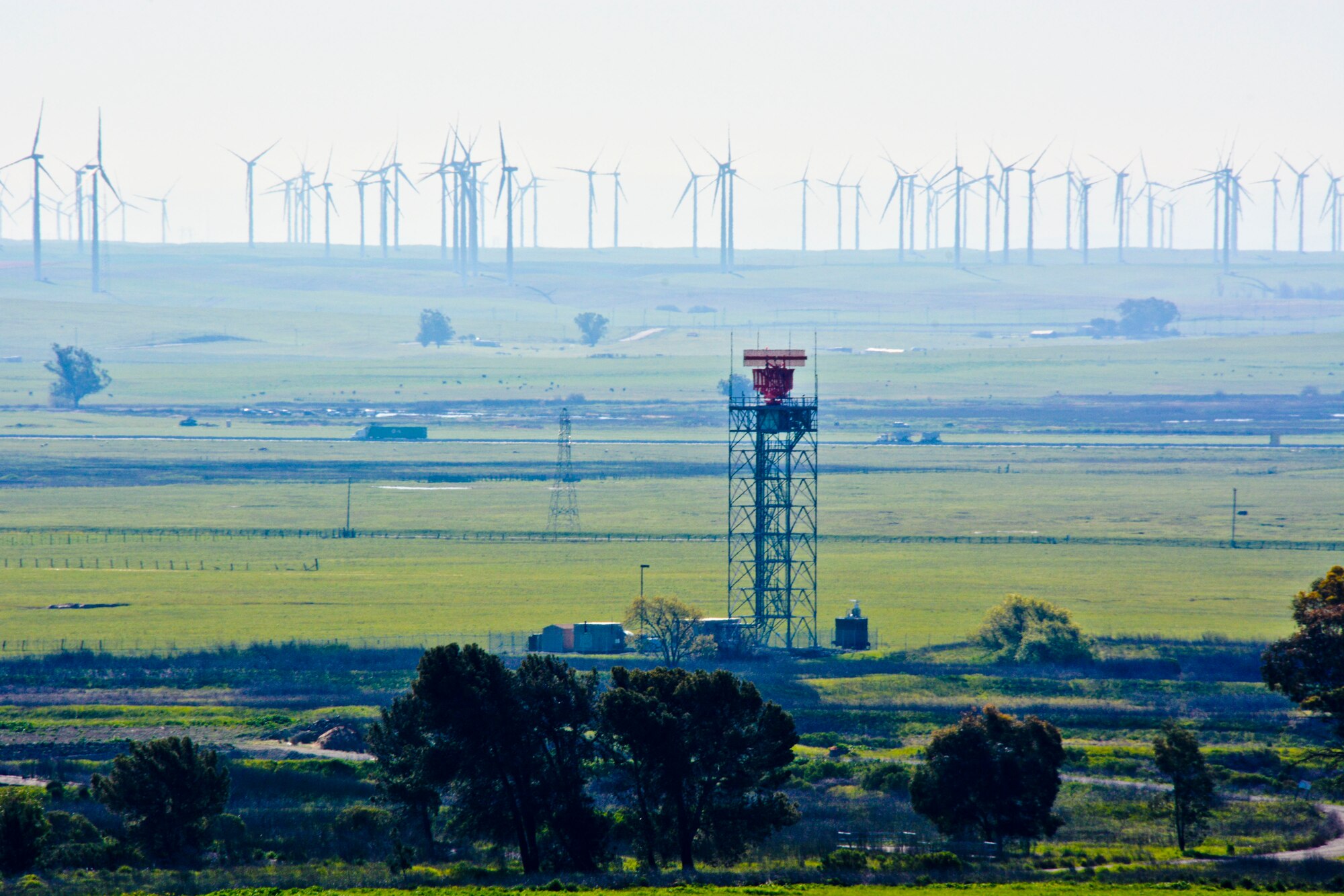 The Digital Airport Surveillance Radar tower, in the foreground, stands to the left of the Light-Wave Radar System March 6 at Travis Air Force Base, Calif. The LWRS is designed to distinguish wind turbines from aircraft and pinpoint the difference on the Travis radar screen. (U.S. Air Force photo by Airman 1st Class Amber Carter)