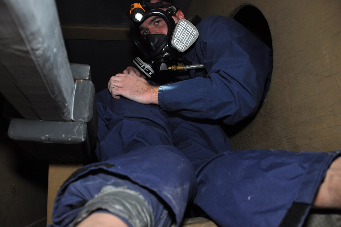 Staff Sgt. Chris Ryan, of the 916th Air Refueling Wing Fuel System Repair Shop, attempts to rescue an injured victim--a 165-pound rubber dummy--from inside a mock KC-135R wing fuel tank during an annual confined space rescue exercise held here, May 11, 2015. Fuel shop personnel worked in conjunction with members of the 916th Safety Office and the 4th Fighter Wing Civil Engineer Fire Department during the exercise. (U.S. Air Force photo/Master Sgt. Wendy Lopedote)