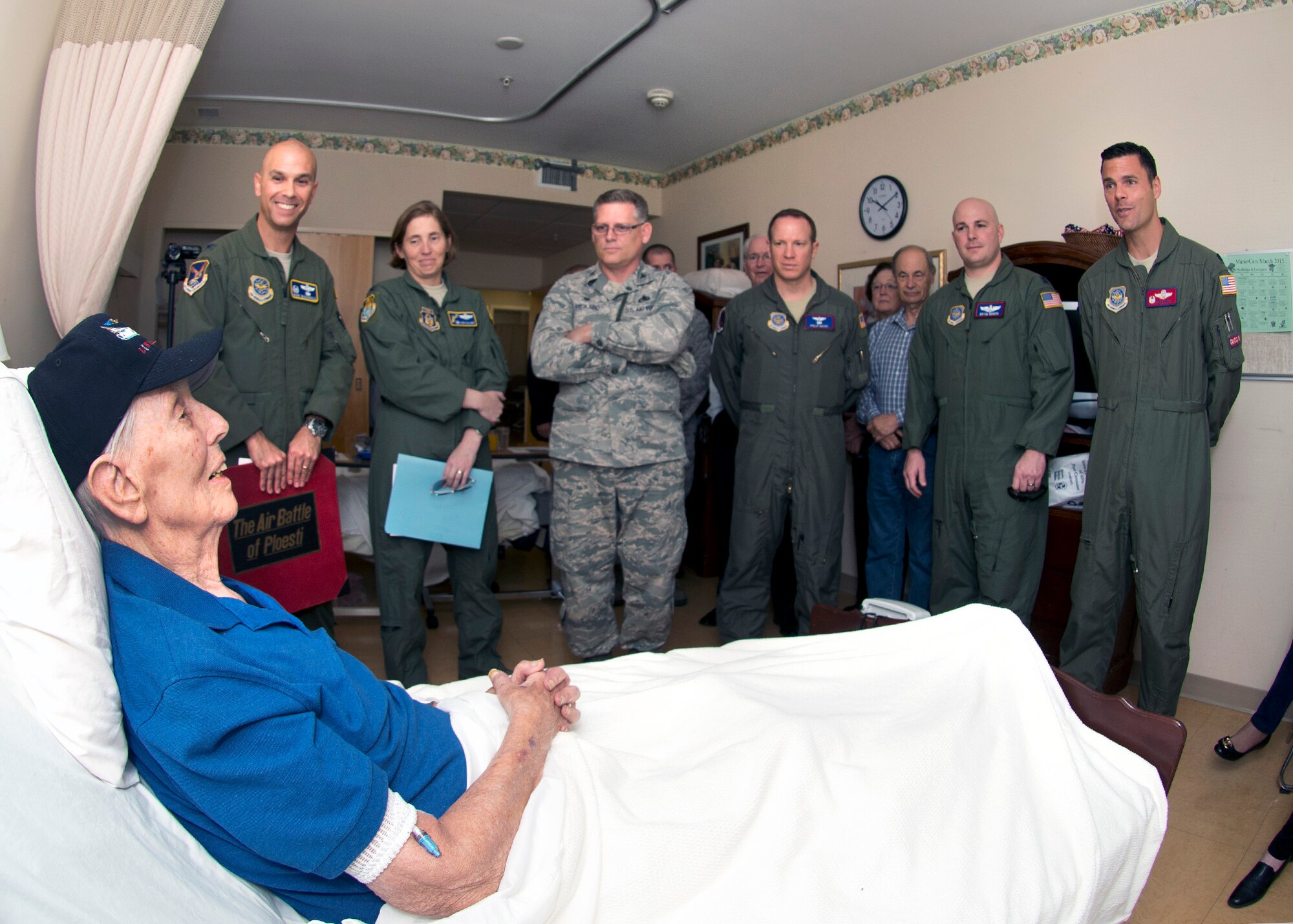 Retired Maj. John Thelen is surrounded March 7 by members of Travis Air Force Base, Calif., leadership. Group-level commanders and crew from all three wings assigned to Trravis drove to Walnut Creek, Calif., to visit the 93-year-old veteran. (U.S. Air Force photo by T.C. Perkins)