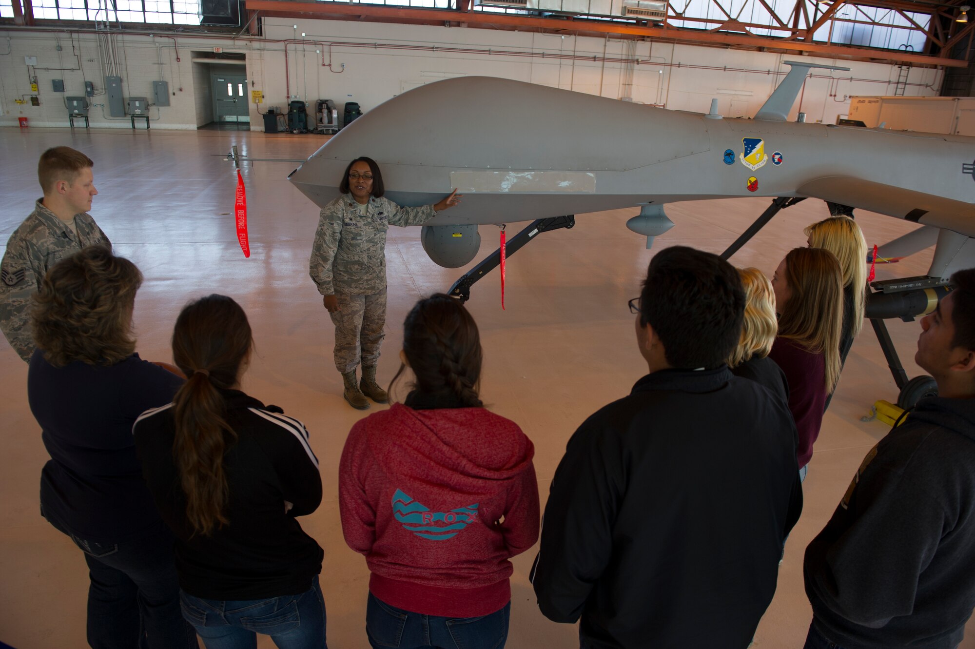 Maj. Jeurney Meekins, 49th Aircraft Maintenance Squadron commander, speaks to the advanced communication capabilities of the MQ-1 remotely piloted aircraft. RPAs feature several transmitting devices to communicate with GPS satellites and Ground Control Stations. (U.S. Air Force photo by Airman 1st Class Aaron Montoya/RELEASED)