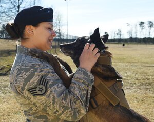 Staff Sgt. Monica Bizallion, 11th Security Forces Support Squadron military working dog handler, bonds with her military working dog, Nirvana, after training at the MWD obstacle course at Joint Base Andrews, Md., Mar. 12, 2015. Team Andrews utilizes more than 30 MWDs to help protect the base, residents and flight line. (U.S. Air Force photo/Airman 1st Class Joshua R. M. Dewberry)