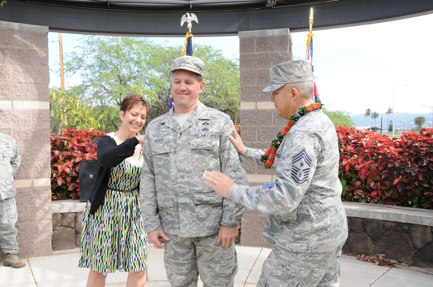 U.S. Air Force retired Chief Master Sgt. of the Air National Guard Denise Jelinski-Hall and Command Chief Master Sgt. Robert S. Lee pin stars on Chief Master Sgt. William A. Parker, Hawaii Air National Guard 154th Civil Engineering Squadron, during a pinning ceremony at Joint Base Pearl Harbor-Hickam on March 8, 2015. Parker was named command chief and senior enlisted leader of the Hawaii National Guard. (U.S. National Guard photo by Airman 1st Class Robert Cabuco)

