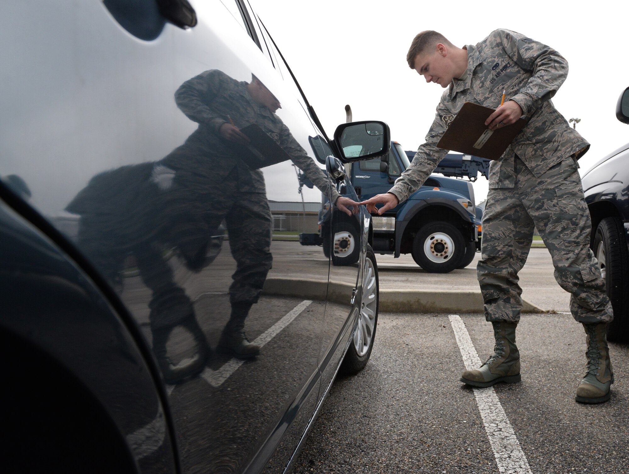 Senior Airman Ryan Fitzgerald, 81st Logistics Readiness Squadron vehicle management and analysis technician, inspects a vehicle March 11, 2015, Keesler Air Force Base, Miss. The more than 40 member maintenance flight repair and oversee more than 420 government vehicles that belong to Keesler. (U.S. Air Force photo by Senior Airman Holly Mansfield)